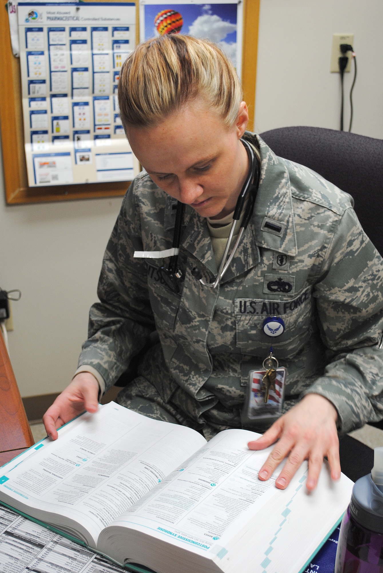 Lt. Stacy Knutson, 341st Medical Group family medicine physician assistant, looks up information in a book to help her better treat a patient.  Knutson describes the Biomedical Services Corps as a “Jack of all Trades” in the medical group as “There is very little we don’t do or can’t make happen,” she says.  (U.S. Air Force photo/Senior Airman Cortney Paxton)