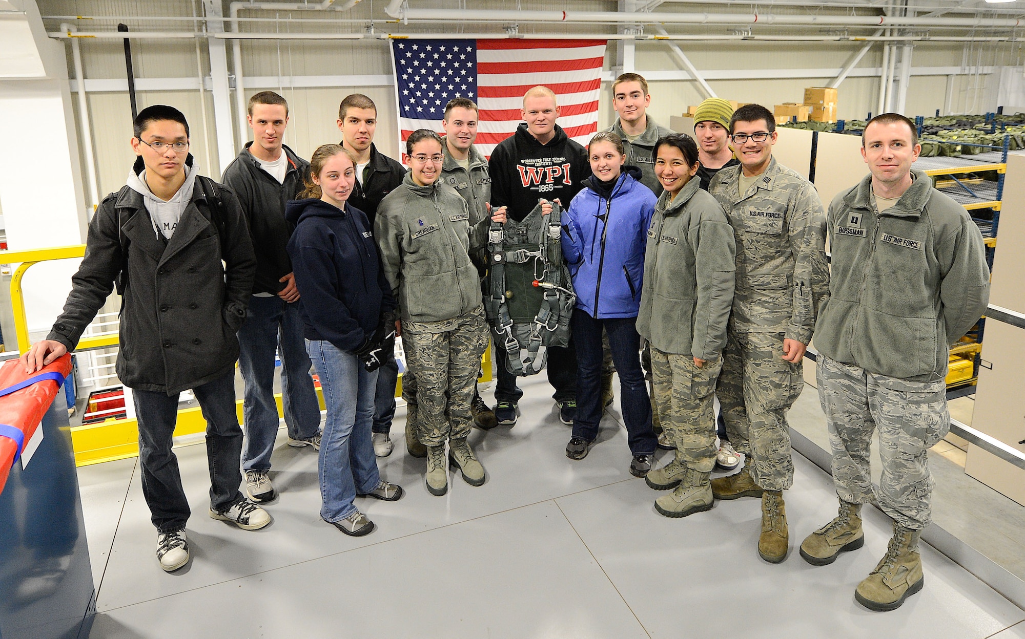 A group of Air Force Reserve Officer Training Corps (AFROTC) cadets from Detachment 340, Worchester, Mass., pose with a parachute inside the Aircrew Flight Equipment section, 436th Operations Support Squadron, Dover Air Force Base, Del., March 6, 2013, during a tour of the base. (U.S. Air Force photo/Greg L. Davis)