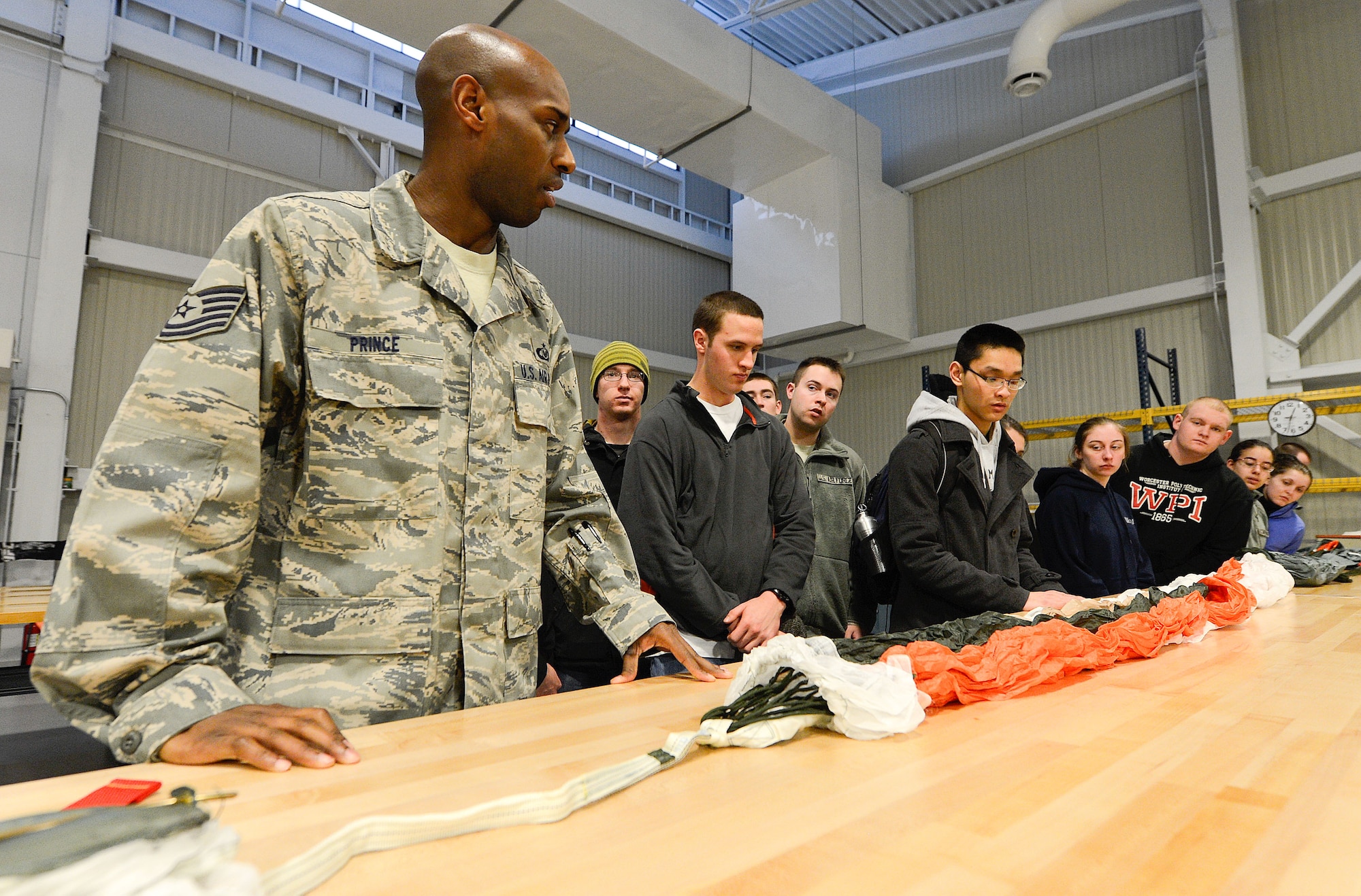 Technical Sergeant Kenyatta Prince, (left), production superintendent, Aircrew Flight Equipment section, 436th Operations Support Squadron, briefs a group of Air Force Reserve Officer Training Corps (AFROTC) cadets from Detachment 340, Worchester, Mass. on the duties, responsibilities and importance of his operation to mission success, Dover Air Force Base, Del., March 6, 2013. (U.S. Air Force photo/Greg L. Davis)