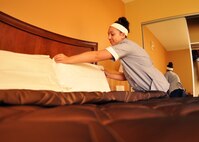 Ruthann Karr, a housekeeper at the Duke Inn and Visiting Quarters, places pillows on a bed prior to the grand-reopening of one of Duke Field’s newest fully renovated lodging facilities March 1, 2013. The renovations corrected decades of substandard lodging for the facilities originally built in the 1950s. (U.S. Air Force photo/Dan Neely)