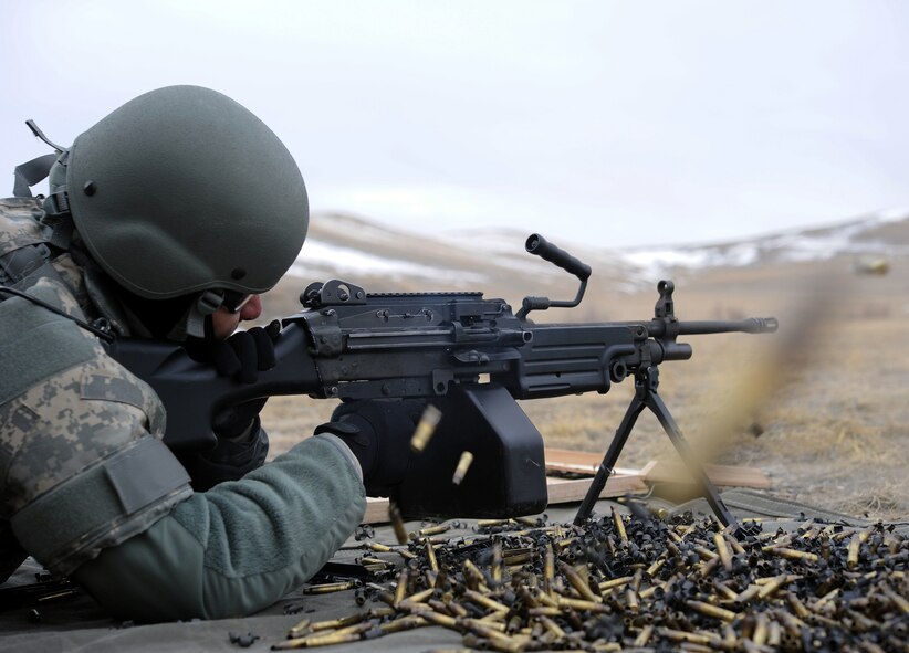 Senior Airman Leonardo Rios, 819th RED HORSE Squadron operations management journeyman, fires the M249 automatic rifle as empty 5.56mm caliber bullet casings are rapidly ejected from the weapon. The M249 can hold 200-rounds for rapid fire. (U.S. Air Force photo/Staff Sgt. R.J. Biermann)