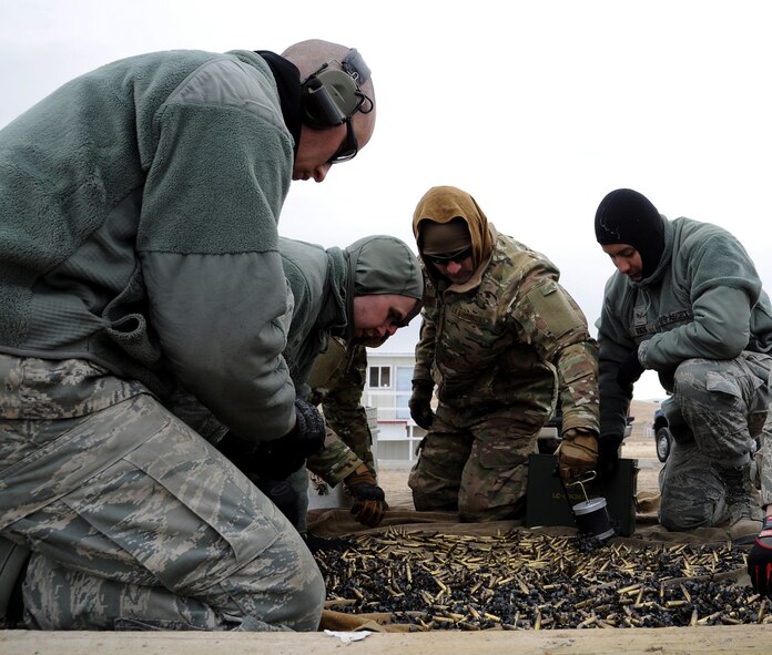 Airmen collect several thousand empty bullet casings and ammunition links after the half-day M249 automatic rifle qualification course Feb. 27 at Fort Harrison in Helena, Mont. The course served 22 Malmstrom Air Force Base Airmen with the necessary hands-on training to become proficient on the weapon. (U.S. Air Force photo/Staff Sgt. R.J. Biermann)