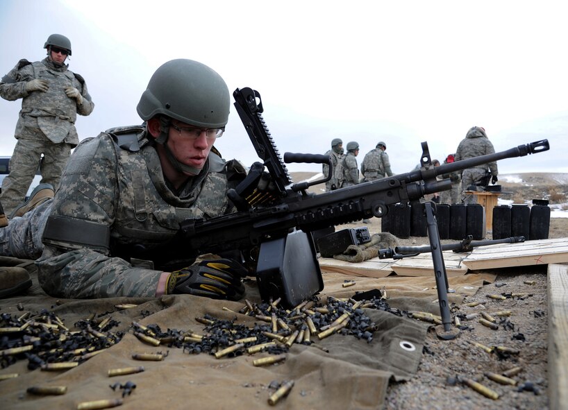 Airman 1st Class ChristpherJerome Reinbold, 819th RED HORSE Squadron heavy equipment operator, reloads his M249 automatic rifle during a qualification course Feb. 27 at Fort Harrison in Helena, Mont. Reinbold had never fired the M249 prior to the course. (U.S. Air Force photo/Staff Sgt. R.J. Biermann)