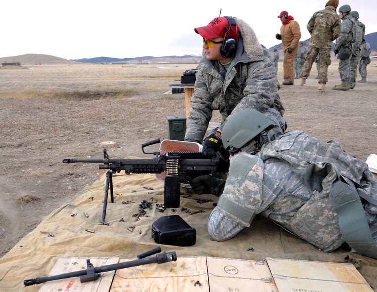 Staff Sgt. Ruben Salazar, Jr., 341st Security Support Squadron Combat Arms instructor, looks to see if his student has hit a target with the M249 automatic rifle. Salazar and other Combat Arms instructors hosted an M249 qualification course Feb. 27 at Fort Harrison in Helena, Mont. (U.S. Air Force photo/Staff Sgt. R.J. Biermann) 