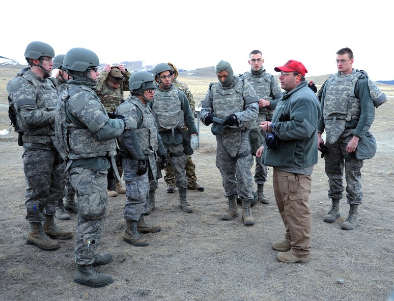 Les Christensen (second from right), 341st Security Support Squadron Combat Arms supervisor, briefs Airmen before an M249 automatic rifle qualification course Feb. 27 at Fort Harrison in Helena, Mont. The half-day course served 22 Malmstrom Air Force Base Airmen with the necessary hands-on training to become proficient on the weapon. (U.S. Air Force photo/Staff Sgt R.J. Biermann)