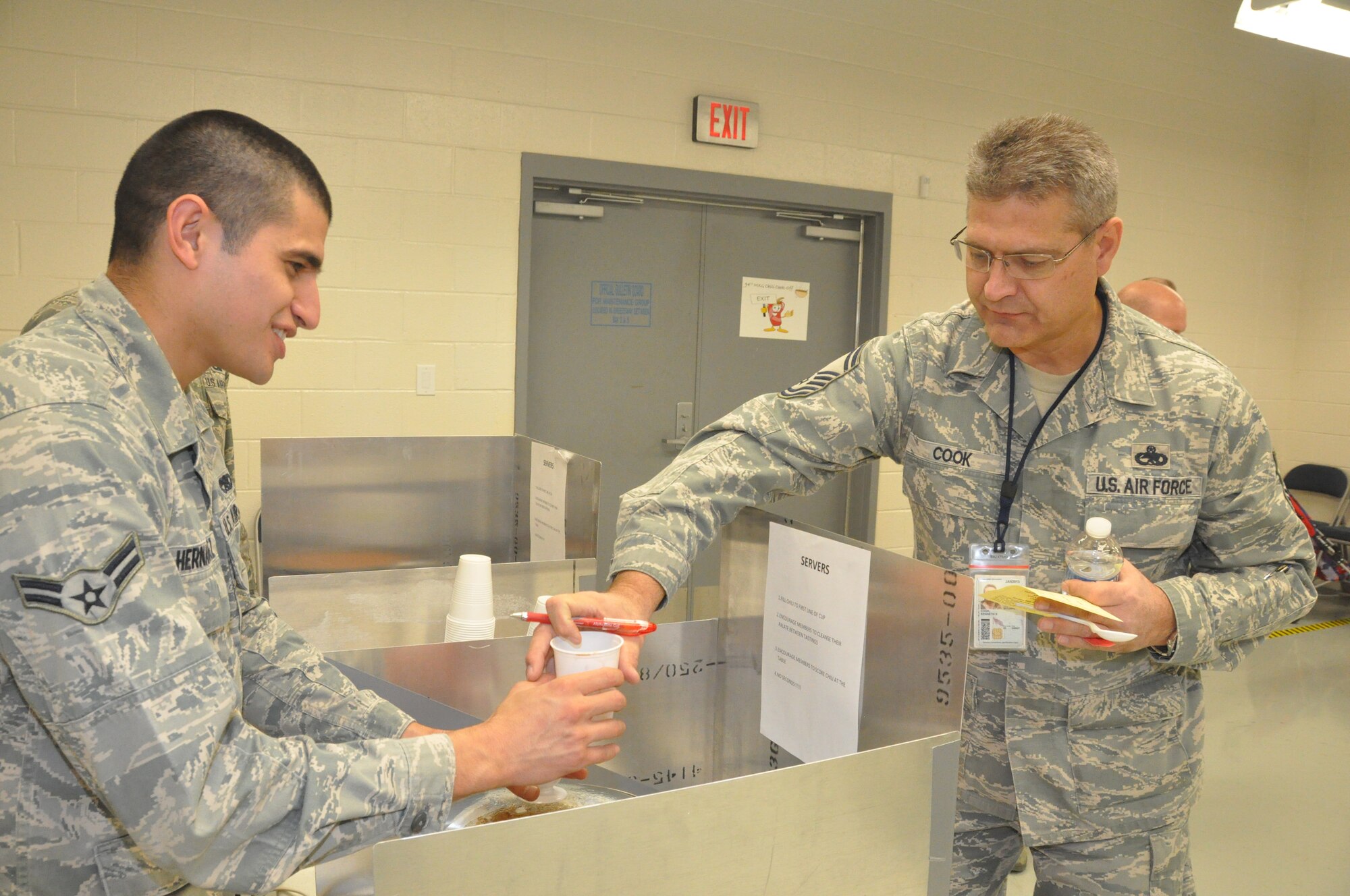 Senior Master Sgt. Kenneth Cook, of the 94th Maintanence Group, takes careful notes before he casts votes for his favorite chilis. The 94th MXG held their 2nd Annual Chili Cook-Off during the December Unit Training Assembly in maintenance bay 2. (U.S. Air Force photo/Senior Airman Christina Bozeman)