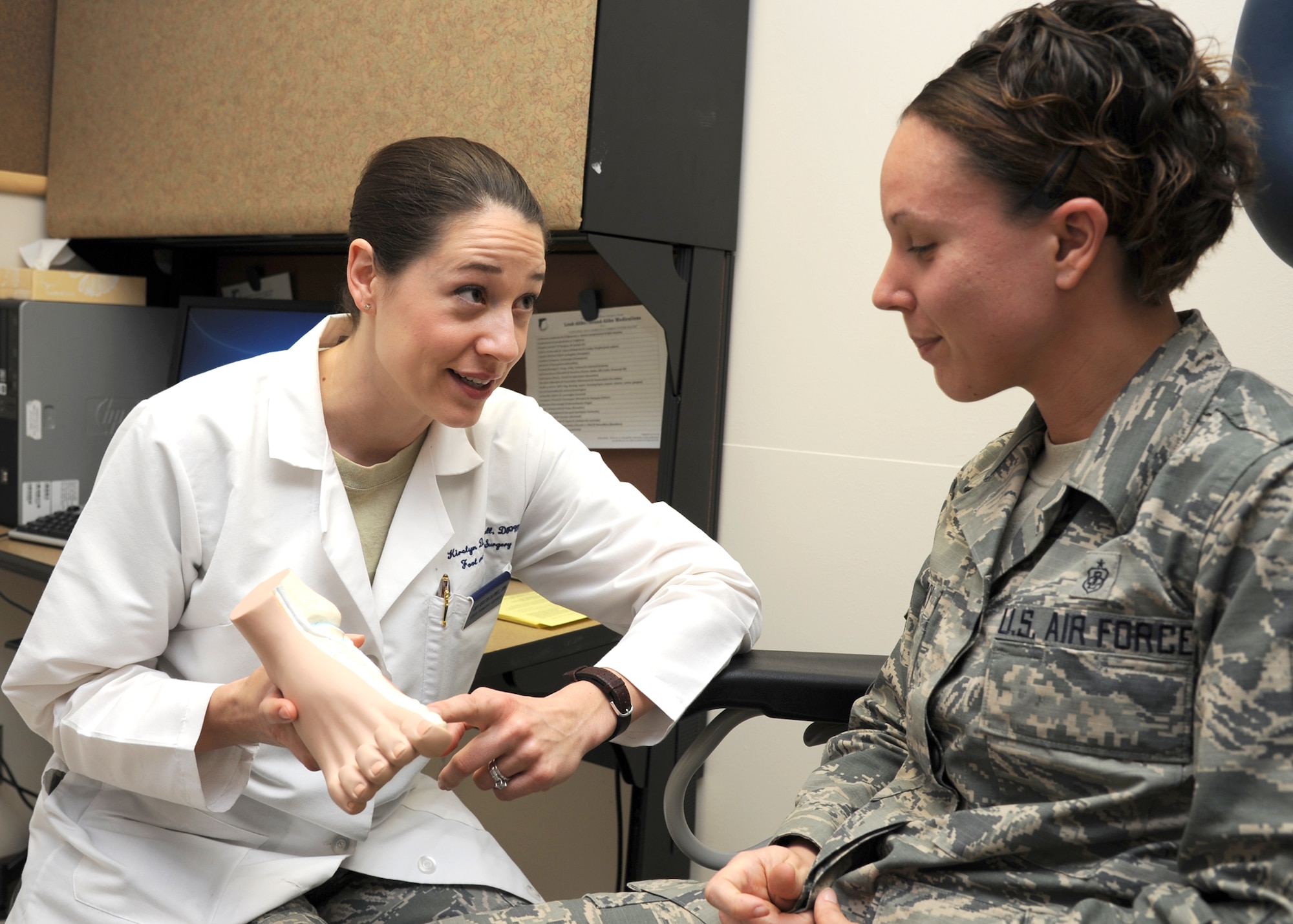 U.S. Air Force Capt. Kirsten Caldwell has a conversation about proper foot care with Staff Sgt. Kelly Yankosky at Wilford Hall Ambulatory Surgical Center, Lackland Air Force Base, Texas, Jan. 23.  Caldwell is a podiatrist and Yankosky is an orthopedic technician, both are assigned to the 59th Medical Operations Group. Podiatrists are a part of the Biomedical Science Corps (BSC) along with 16 other medical career fields. BSC Appreciation week is recognized in the month of March.  (U.S. Air Force photo/Mr. Harold China)