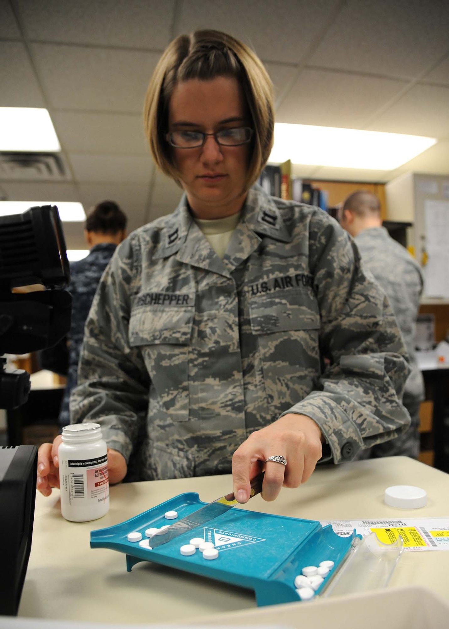 U.S. Air Force Capt. Nicole Deschepper, a 59th Patient Squadron pharmacist, counts pills while filling prescriptions for military members at Reid Clinic on Joint Base San Antonio, Texas, Feb. 16.  Pharmacists are a part of the Biomedical Science Corps (BSC) along with 16 other medical career fields. BSC Appreciation week is recognized in the month of March. (U.S. Air Force photo/Staff Sgt. Kevin Iinuma)