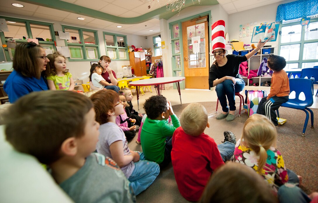 Eva Burley, reads “The Cat in the Hat” to a group of 3-to-5-year-old children during a Read Across America event at the Child Development Center at Ellsworth Air Force Base, S.D., March 1, 2013. Read Across America is a nation-wide program which exposes children to literature and inspires them to read. (U.S. Air Force photo by Airman 1st Class Zachary Hada/Released)