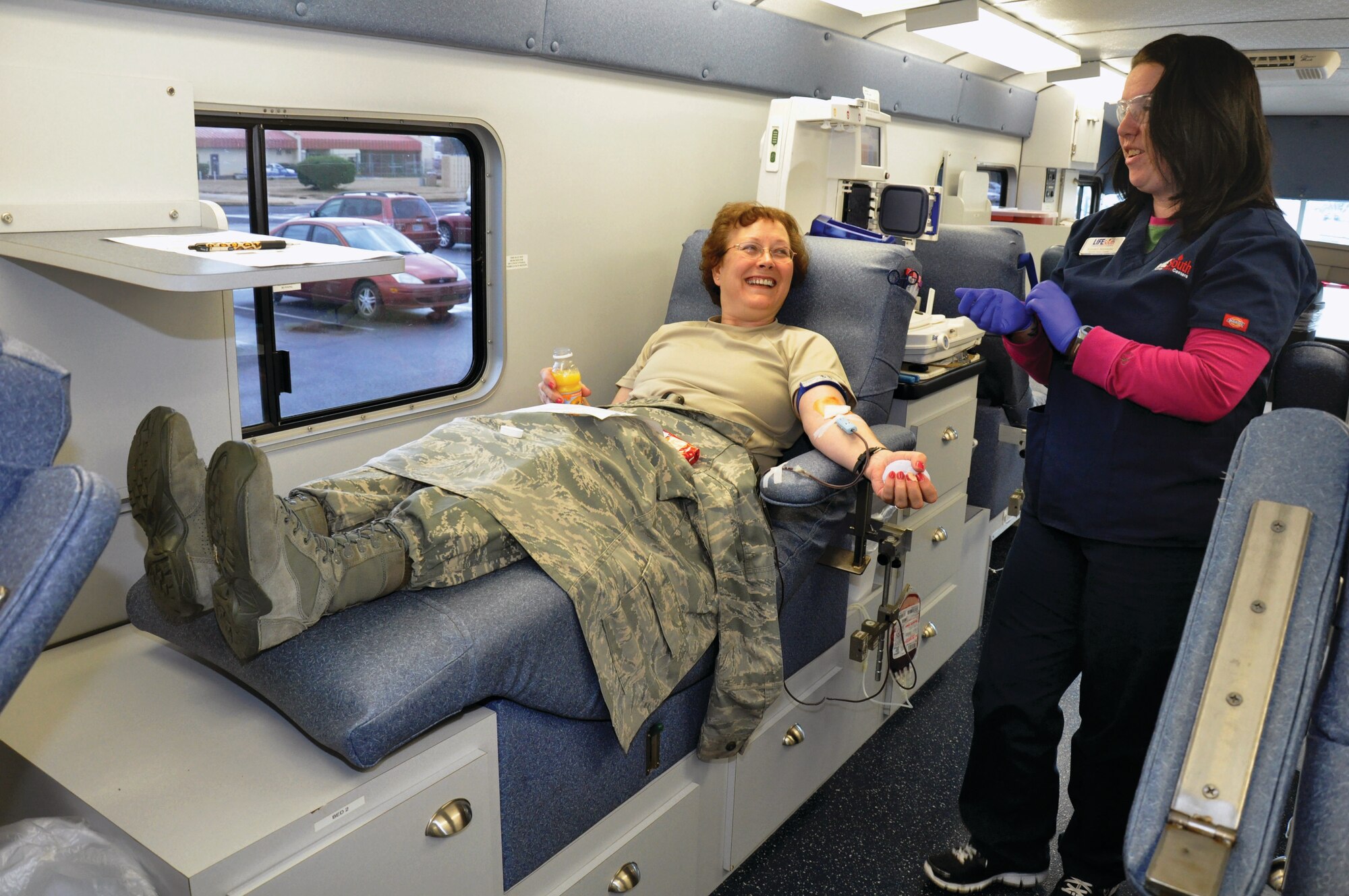 Senior Master Sgt. Martha Roy chats with LifeSouth blood mobile technician Kenall Summers while making her first donation in five years. (Air Force Photo by By Tech. Sgt. Jay Ponder)