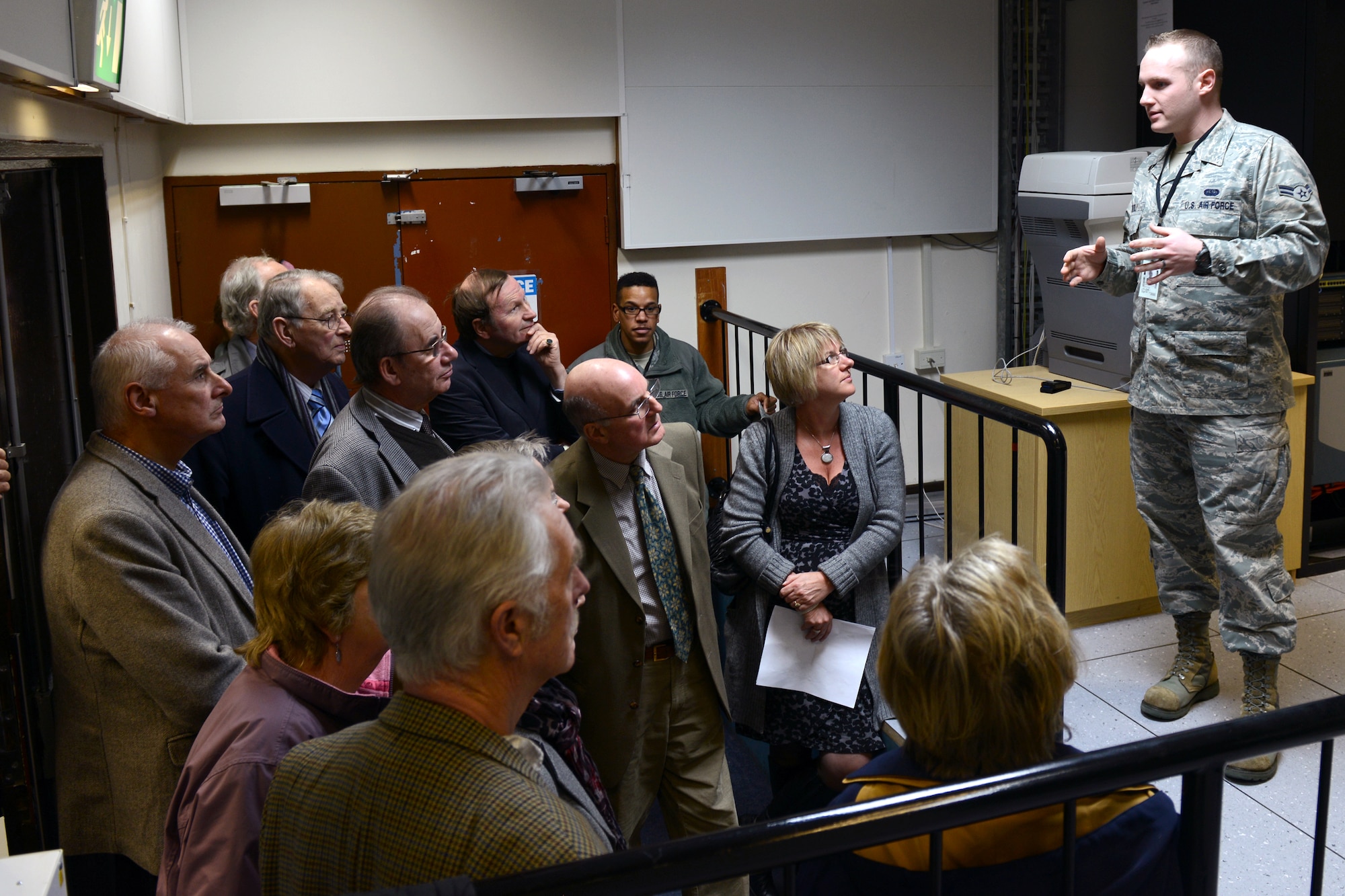 RAF CROUGHTON, United Kingdom – Airman 1st Class Jordan Heatly, 422nd Communications Squadron RF Transmission Systems, briefs members of the Aynho Conservative Club and Rotary Club of Brackley on the mission of the Satellite Communications Work center inside Building 180 (PL/1 SATCOM facility) at RAF Croughton. The groups toured the 422nd CS March 5. (U.S. Air Force photo by Tech. Sgt. Chrissy Best)