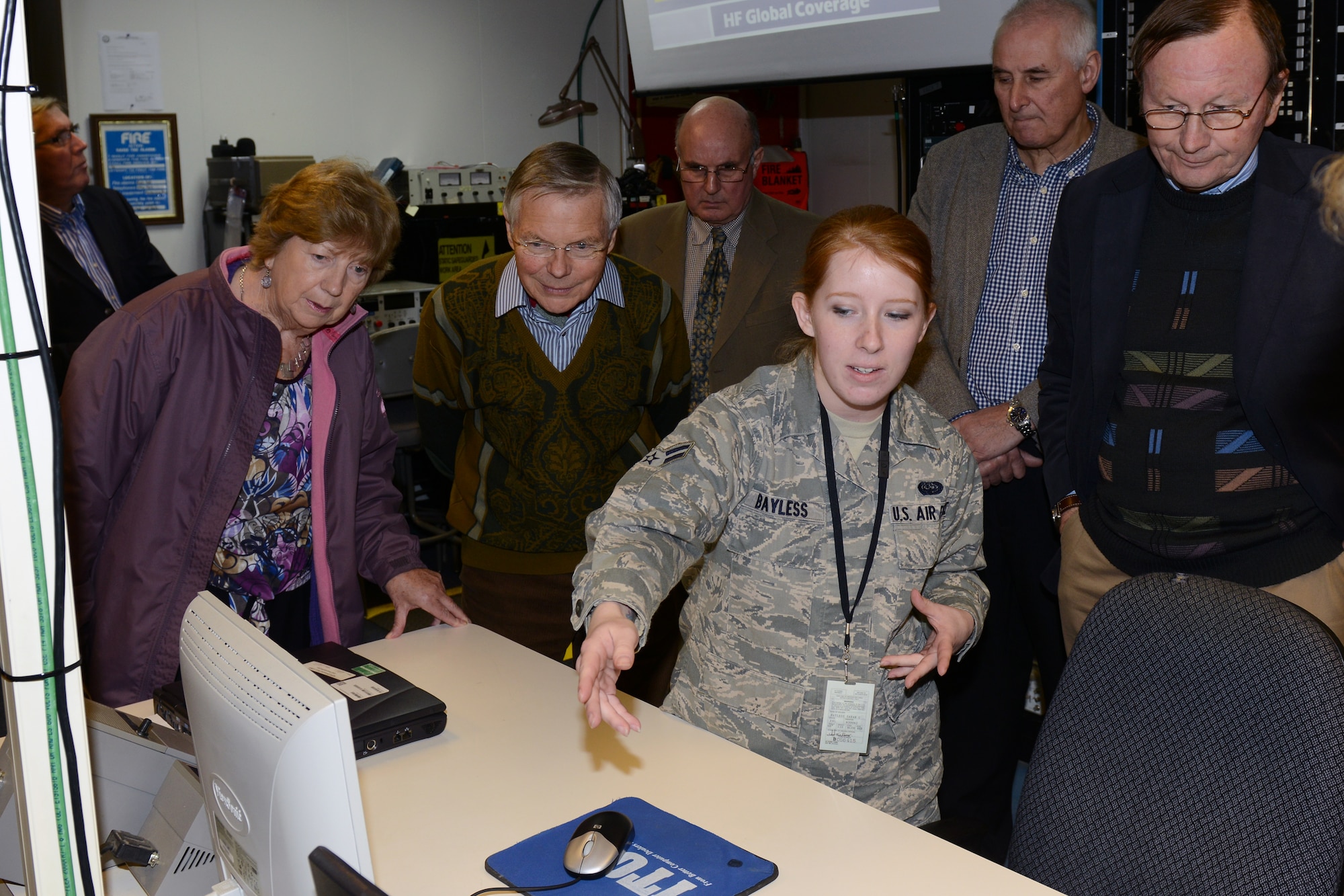 RAF CROUGHTON, United Kingdom – Airman 1st Class Sarah Bayless, 422nd Communications Squadron RF Transmission Systems, briefs members of the Aynho Conservative Club and Rotary Club of Brackley on the mission of the High Frequency Global Communications Systems Work center inside Building 180 (PL/1 SATCOM facility) at RAF Croughton. The groups toured the 422nd CS March 5. (U.S. Air Force photo by Tech. Sgt. Chrissy Best)