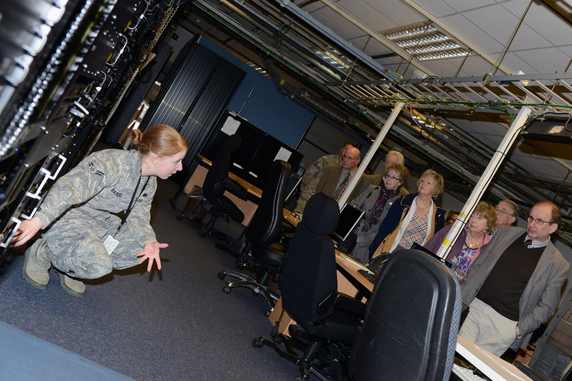 RAF CROUGHTON, United Kingdom – Airman 1st Class Sarah Bayless, 422nd Communications Squadron RF Transmission Systems, briefs members of the Aynho Conservative Club and Rotary Club of Brackley on the mission of the High Frequency Global Communications Systems Work center inside Building 180 (PL/1 SATCOM facility) at RAF Croughton. The groups toured the 422nd CS March 5. (U.S. Air Force photo by Tech. Sgt. Chrissy Best)