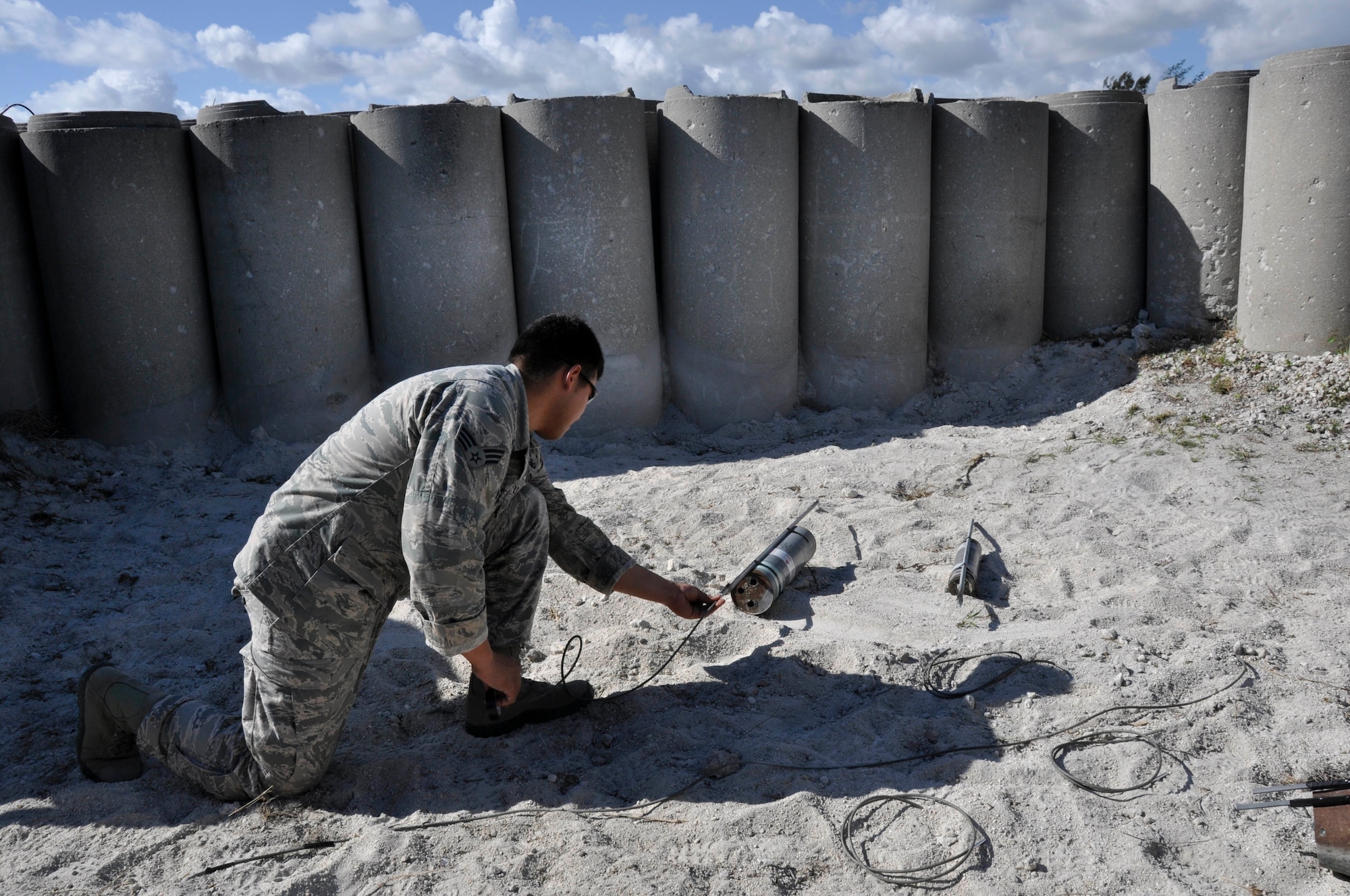 Senior Airman Fernando Olivias Fortin, 482nd Civil Engineering Squadron Explosive Ordnance Disposal flight technician, places a flex liner shape charge on an Mk 58 at Homestead Air Reserve Base, Fla., Feb. 9. EOD neutralizes used and unused ordnance that remain after an incident, accident, or enemy attack which presents a threat to military operations, installations, personnel or material. They tackle a range of contingencies from neutralizing explosives and bombs, to recovering found ordnance, and supporting the secret service, aircraft crashes, incident response teams, and post attack base recovery operations. (U.S. Air Force photo/Senior Airman Nicholas Caceres)