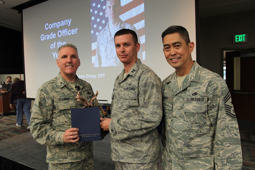 Brig. Gen. Jay Flournoy, Air Reserve Personnel Center commander, and Chief Master Sgt. Brian Wong, ARPC command chief, present the ARCP Company Grade Officer of the Year award to Capt. Adam Ertsey. Flournoy honored ARPC's 2012 Outstanding Performers of the Year as well as their A1 annual award winners during commander's call March 6, 2013, on Buckley Air Force, Colo. (U.S. Air Force photo/Tech. Sgt. Rob Hazelett)