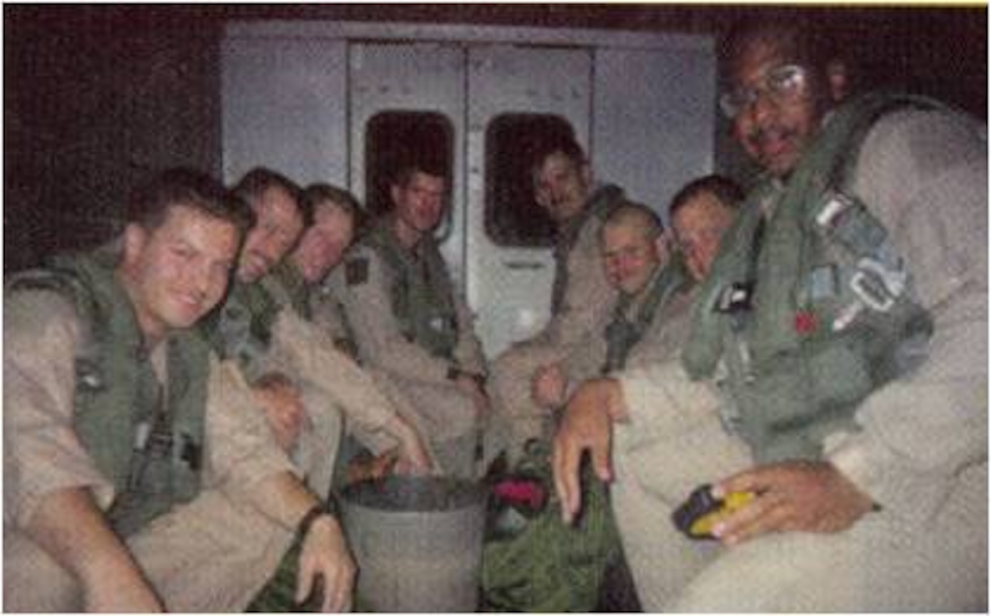 History-making aircrews from the 37th Bomb Squadron ride in the back of a "bread truck" on their way to the B-1 bomber they'll use on the second night of Operation Desert Fox, December 1998. One B-1 from each deployed bomber squadron – the 37th BS and the 9th BS, Dyess Air Force Base, Texas – flew on the second and third nights of ODF. (U.S. Air Force courtesy photo/Released)