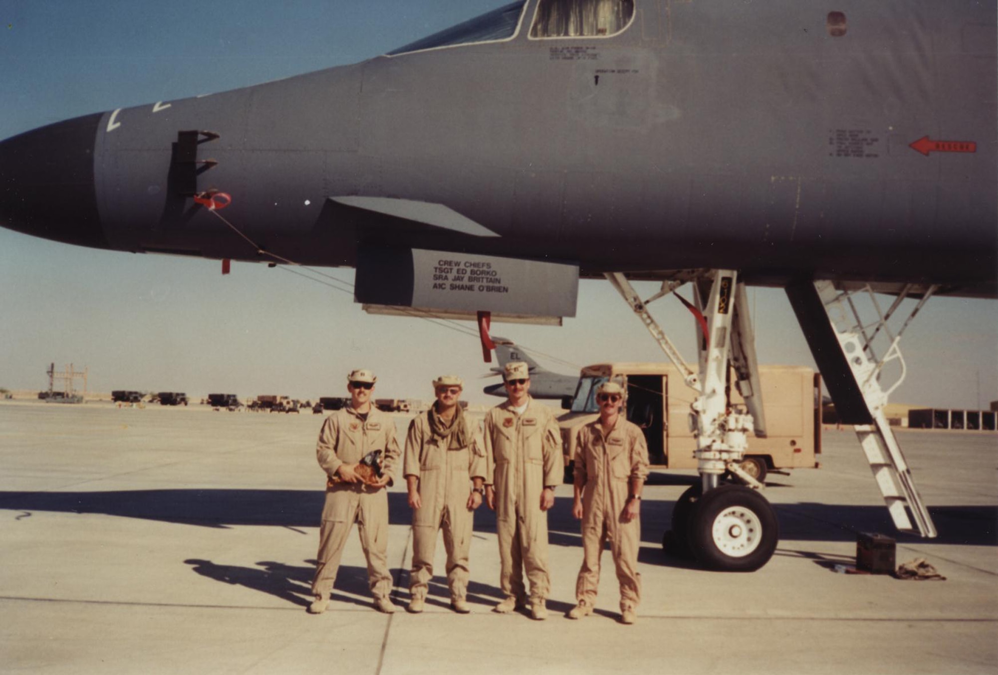 (From left to right) Captains John Martin, Joe Reidy, Jeffrey Taliaferro and Randy Kaufman stand in front of 37th Bomb Squadron aircraft number 86-0102 during Operation Desert Fox on the flightline at Thumrait Air Base, Oman, Dec. 19, 1998. Nicknamed "Moon Doggie" at the time, the side of 86-0102 is freshly painted with a single black bomb after the crew's drop on the preceding night. (Lt. Col. John Martin courtesy photo/Released)