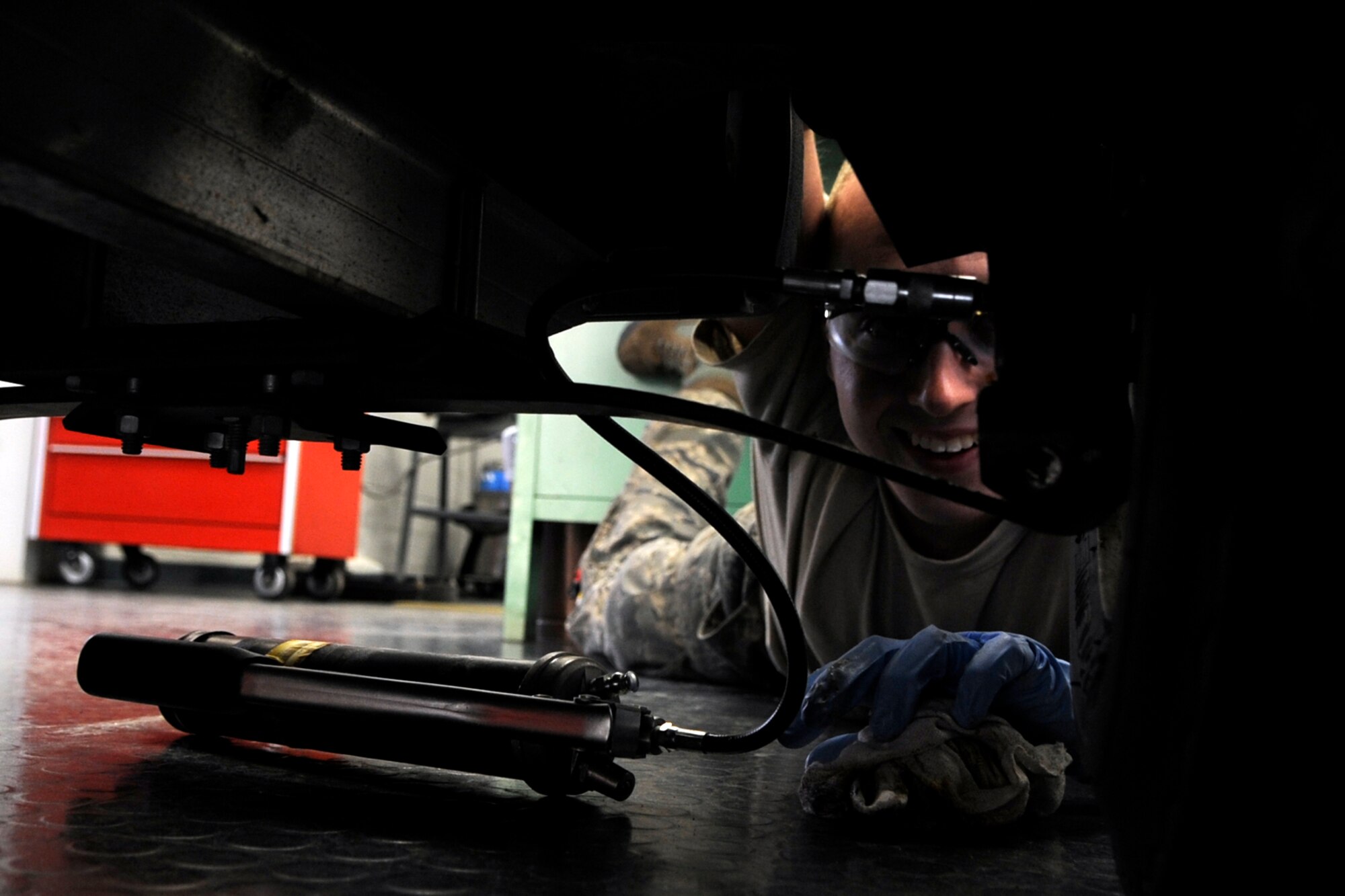 Airman 1st Class Justin May, a hydraulics journeyman assigned to the 307th Maintenance Squadron, connects the tip of a grease gun hose to the grease fitting on the front end of a FOTAMOT, (four-seated other than aircraft means of transportation) or golf cart, in the hydraulics shop at Barksdale Air Force Base, La., March 5, 2013. When not performing maintenance on jet aircraft at Barksdale, 307 MXS personnel work on and perform “preventive” maintenance on numerous non-flying vehicles and equipment behind the scenes. These seldom publicized maintenance procedures make it possible for Air Force maintainers to keep Air Force jets in the air and on the job, protecting American interests around the world. (U.S. Air Force photo by Master Sgt. Jeff Walston)   