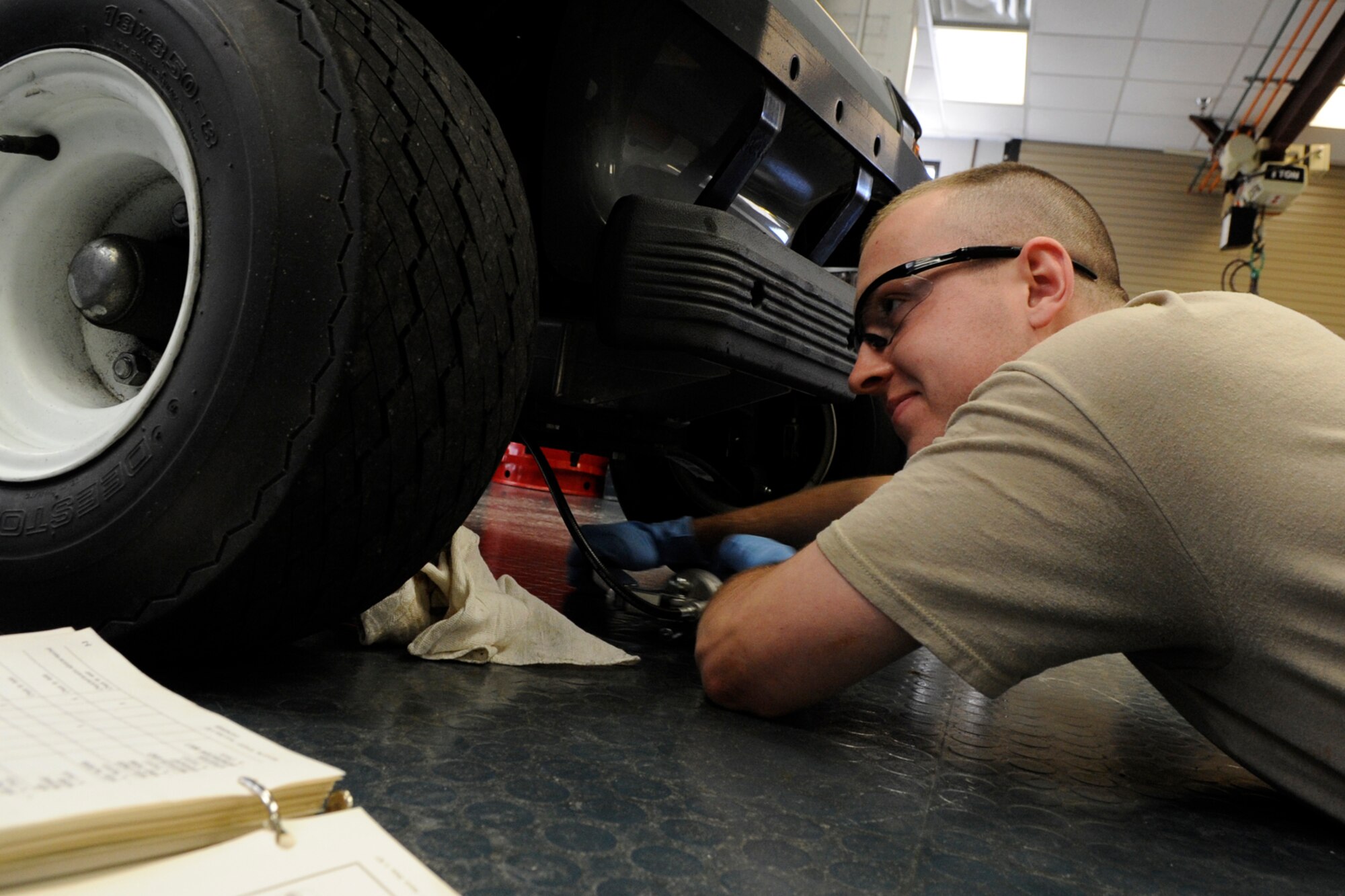Airman 1st Class Justin May, a hydraulics journeyman assigned to the 307th Maintenance Squadron, greases the front end of a FOTAMOT, (four-seated other than aircraft means of transportation) or golf cart, in the hydraulics shop at Barksdale Air Force Base, La., March 5, 2013. When not performing maintenance on jet aircraft at Barksdale, 307 MXS personnel work on and perform “preventive” maintenance on numerous non-flying vehicles and equipment behind the scenes. These seldom publicized maintenance procedures make it possible for Air Force maintainers to keep Air Force jets in the air and on the job, protecting American interests around the world. (U.S. Air Force photo by Master Sgt. Jeff Walston)   