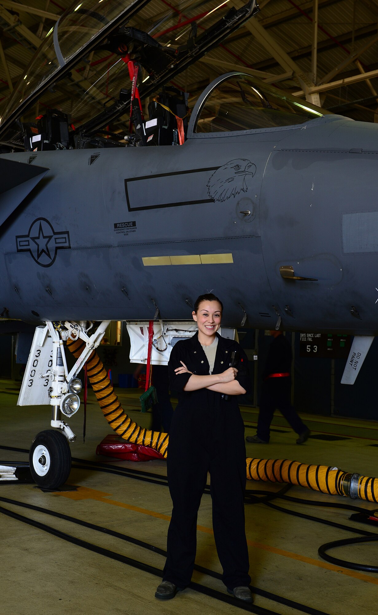 ROYAL AIR FORCE LAKENHEATH, England - Senior Airman Annette Bieniek, 48th Equipment Maintenance Squadron inspection section journeyman, stands in front of one of the F-15E Strike Eagles she is responsible for inspecting.  Bieniek's story of overcoming adversity is one of several being featured during Womens' History Month.  (U.S. Air Force photo by Staff Sgt. Stephanie Mancha)