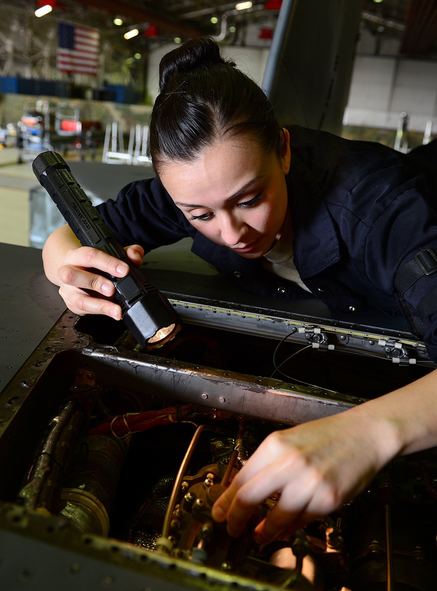 ROYAL AIR FORCE LAKENHEATH, England - Senior Airman Annette Bieniek, 48th Equipment Maintenance Squadron inspection section journeyman, inspects the primary heat exchanger of an F-15E Strike Eagle March 5, 2013. Bieniek's story of overcoming adversity is one of several being featured during Womens' History Month.  (U.S. Air Force photo by Staff Sgt. Stephanie Mancha)