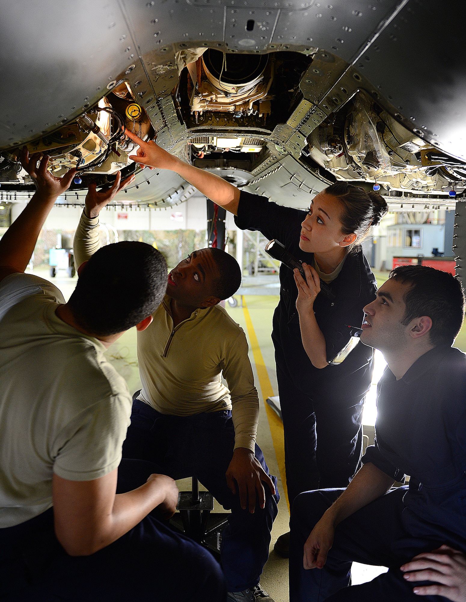 ROYAL AIR FORCE LAKENHEATH, England - Senior Airman Annette Bieniek, 48th Equipment Maintenance Squadron inspection section journeyman, trains Airmen on the proper safety wire in a central gear box of an F-15E Strike Eagle March 5, 2013. Bieniek's story of overcoming adversity is one of several being featured during Womens' History Month.  (U.S. Air Force photo by Staff Sgt. Stephanie Mancha)