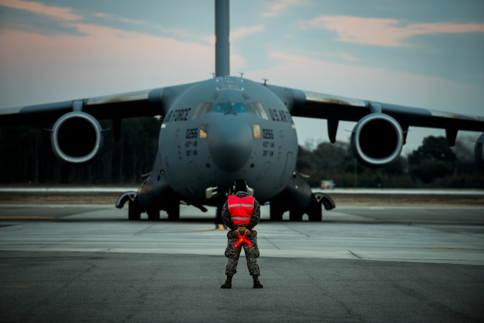 Airman 1st Class Damien Goodman, 437th Aircraft Maintenance Squadron crew chief, marshals a C-17A Globemaster III before a flight Feb. 28, 2013, at Joint Base Charleston - Air Base, S.C. The 437th AMXS inspects, services and maintains assigned C-17 aircraft to enable the aircraft to perform assigned global airlift missions ranging from combat support operations and humanitarian relief to aeromedical evacuations. (U.S. Air Force photo/ Senior Airman George Goslin)