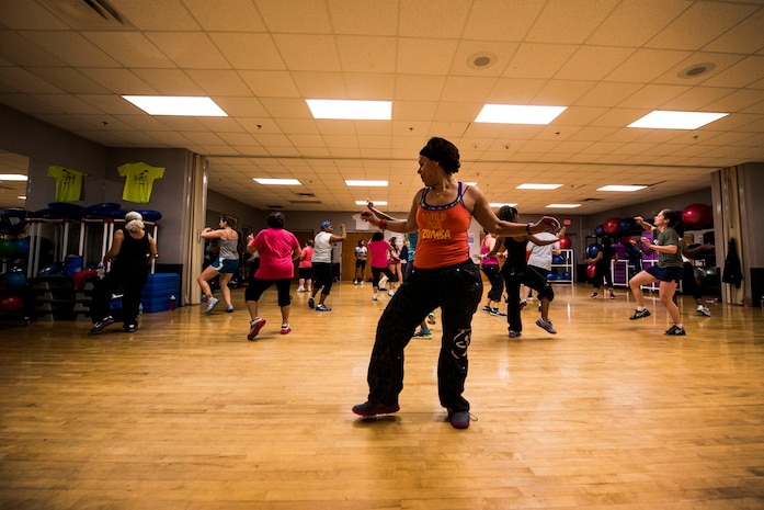 Elaine Domenech, Zumba instructor, leads a Zumba class Feb. 27, 2013, at the Joint Base Charleston - Air Base Fitness Center. Zumba involves dance and aerobic elements, incorporating Hip-hop, Soca, Samba, Salsa, Merengue, Mambo, martial arts, and some Bollywood and belly dance moves. The Zumba classes are held 4:35 to 5:35 p.m. on Mondays; noon to 1 p.m. on Tuesdays; 11 to 11:50 a.m. and 4:35 to 5:35 p.m. on Wednesdays; noon to 1 p.m. and 7 to 8 p.m. on Thursdays; 4:35 to 5:35 p.m. on Fridays and 9:30 to 10:30 a.m. on Saturdays. (U.S. Air Force photo/ Senior Airman George Goslin)