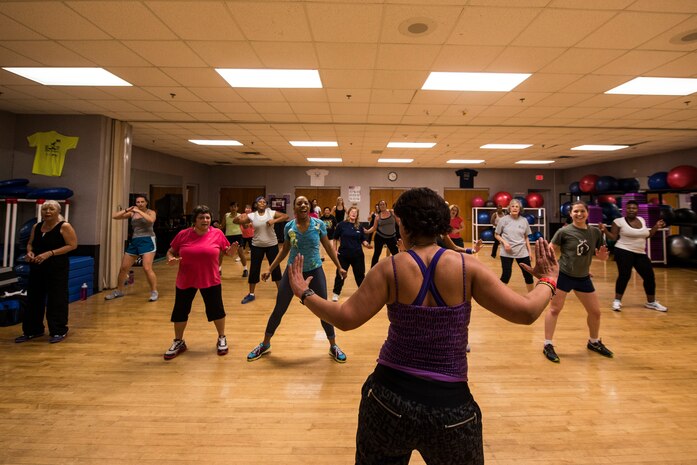 Elaine Domenech, Zumba instructor, demonstrates dance movies during a Zumba class Feb. 27, 2013, at the Joint Base Charleston - Air Base Fitness Center. Zumba involves dance and aerobic elements, incorporating Hip-hop, Soca, Samba, Salsa, Merengue, Mambo, martial arts, and some Bollywood and belly dance moves. The Zumba classes are held 4:35 to 5:35 p.m. on Mondays; noon to 1 p.m. on Tuesdays; 11 to 11:50 a.m. and 4:35 to 5:35 p.m. on Wednesdays; noon to 1 p.m. and 7 to 8 p.m. on Thursdays; 4:35 to 5:35 p.m. on Fridays and 9:30 to 10:30 a.m. on Saturdays. (U.S. Air Force photo/ Senior Airman George Goslin)