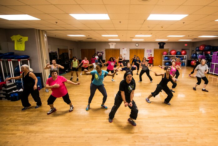 Elaine Domenech, Zumba instructor, leads a Zumba class Feb. 27, 2013, at the Joint Base Charleston - Air Base Fitness Center. Zumba involves dance and aerobic elements, incorporating Hip-hop, Soca, Samba, Salsa, Merengue, Mambo, martial arts, and some Bollywood and belly dance moves. The Zumba classes are held 4:35 to 5:35 p.m. on Mondays; noon to 1 p.m. on Tuesdays; 11 to 11:50 a.m. and 4:35 to 5:35 p.m. on Wednesdays; noon to 1 p.m. and 7 to 8 p.m. on Thursdays; 4:35 to 5:35 p.m. on Fridays and 9:30 to 10:30 a.m. on Saturdays. (U.S. Air Force photo/ Senior Airman George Goslin)