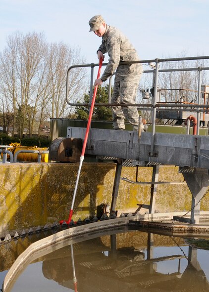 Airman 1st Class Andrew Burdette, 100th Civil Engineer Squadron Water and Fuels Maintenance journeyman from Victorville, Calif., cleans primary clarifiers to ensure optimum performance Feb. 28, 2013, at RAF Mildenhall, England. The shop has seven military service members and six civilians working seven days-a-week to ensure the plants are 100 percent mission-ready. (U.S. Air Force photo by Gina Randall/Released)