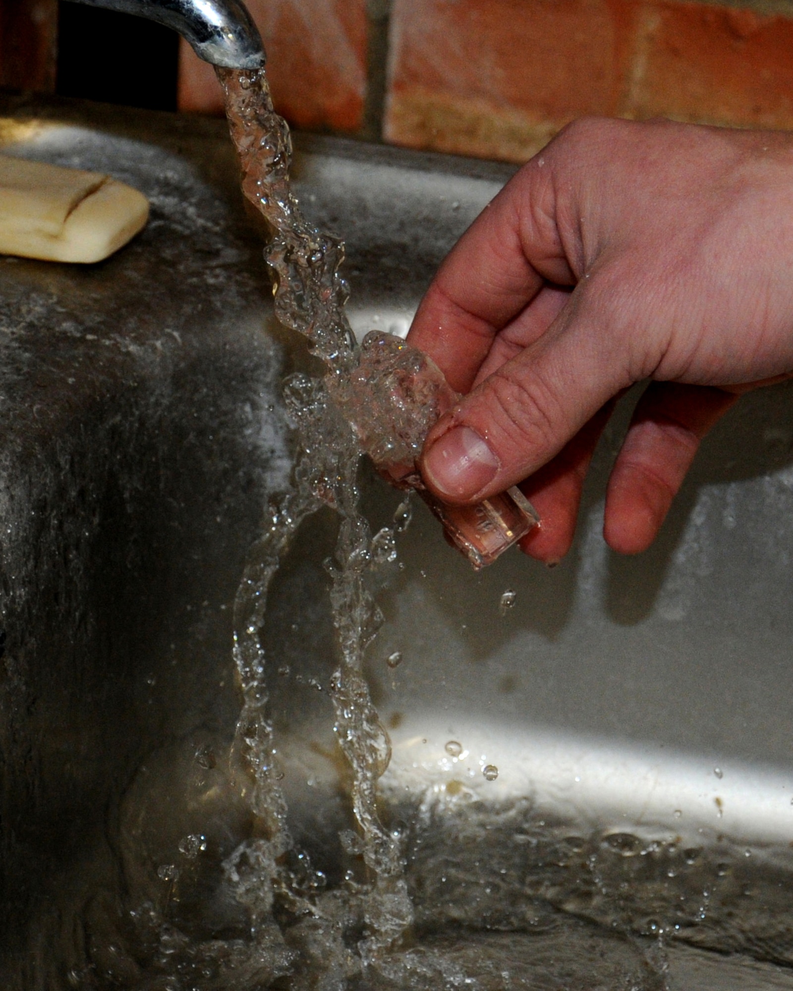 Airman 1st Class Andrew Burdette, 100th Civil Engineer Squadron Water and Fuels Maintenance journeyman from Victorville, Calif., takes a sample of the base water supply to ensure chlorine levels are correct Feb. 28, 2013, at RAF Mildenhall, England. Safe chlorine levels ensure clean water, also known as potable water, is safe to drink. The shop is responsible for the cleansing and distribution of all potable water on base. (U.S. Air Force photo by Gina Randall/Released)