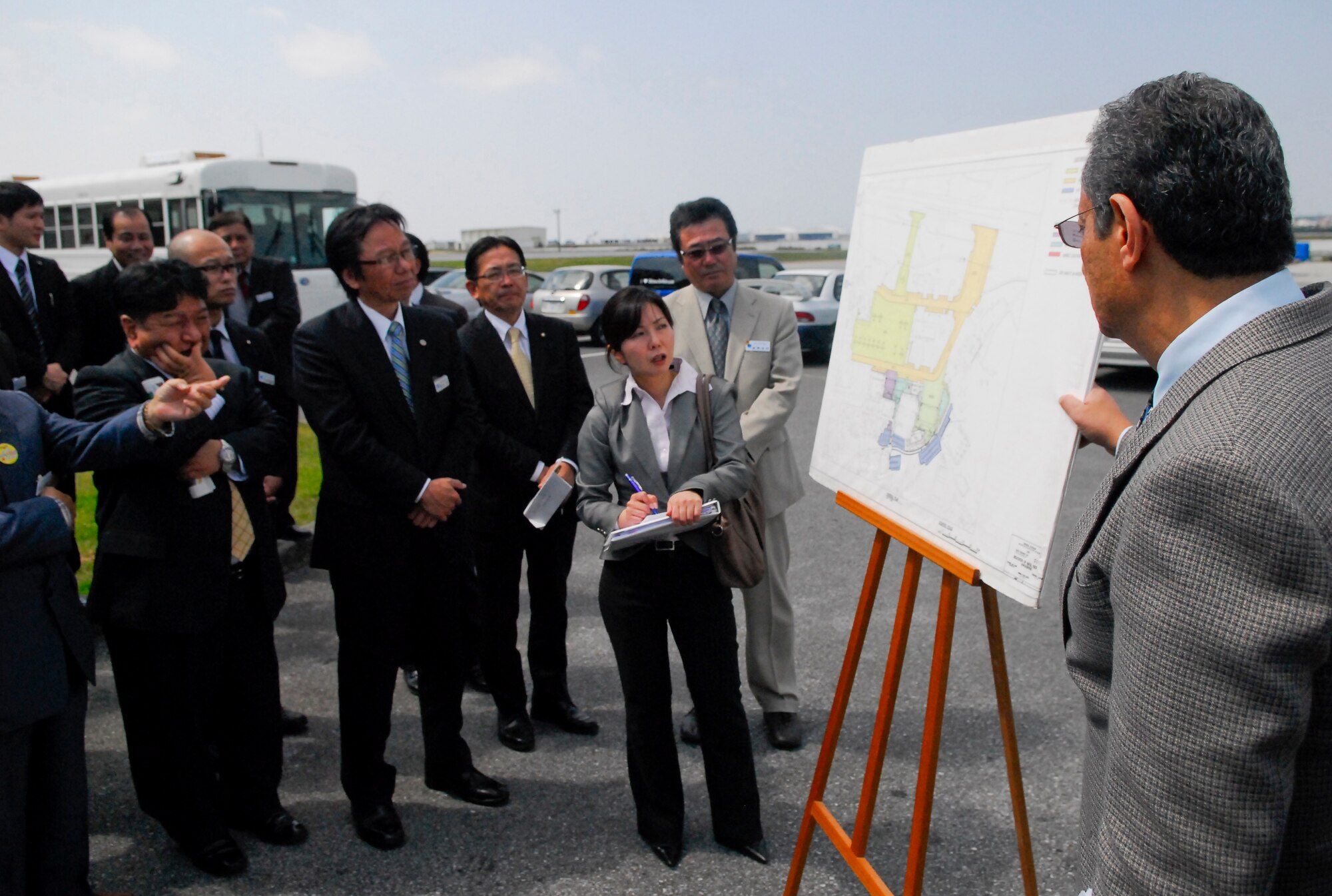 Hani Rophael, 718th Civil Engineer Squadron chief of Government of Japan related programs, briefed Hiroshi Toyama, Kadena Town mayor, and members of his staff on plans to relocate Navy aircraft from the flightline area near Kadena Town to the inner side of the flightline in order to reduce the noise impact to the local community on Kadena Air Base, Japan, March 7, 2013. Approximately 40 newly-elected Kadena Town assembly members visited Kadena for a base tour and a wing mission briefing. (U.S. Air Force photo/Maj. Christopher Anderson)