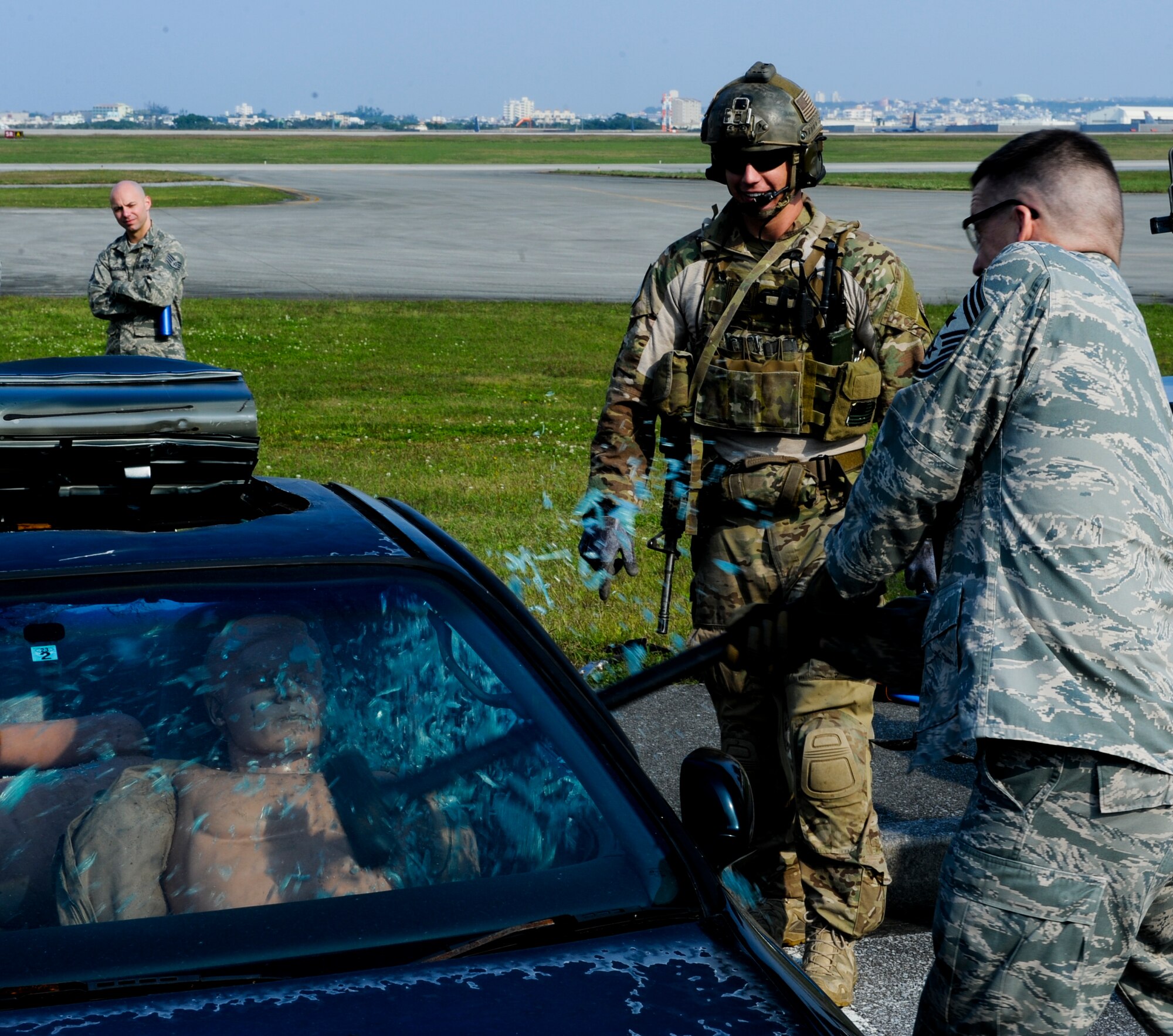 U.S. Air Force Chief Master Sgt. Douglas McIntyre, 5th Air Force command chief, tries to get a simulated victim out of a vehicle during a vehicle extrication demonstration with the 31st Rescue Squadron on Kadena Air Base, Japan, March 6, 2013. The 31st RQS trains, equips and employs combat ready pararescue specialists. The pararescuemen are experts in medical care and small-unit tactics providing survivor contact, treatment and extraction during combat rescue operations in hostile or denied territory.  (U.S. Air Force photo/Airman 1st Class Justin Veazie)