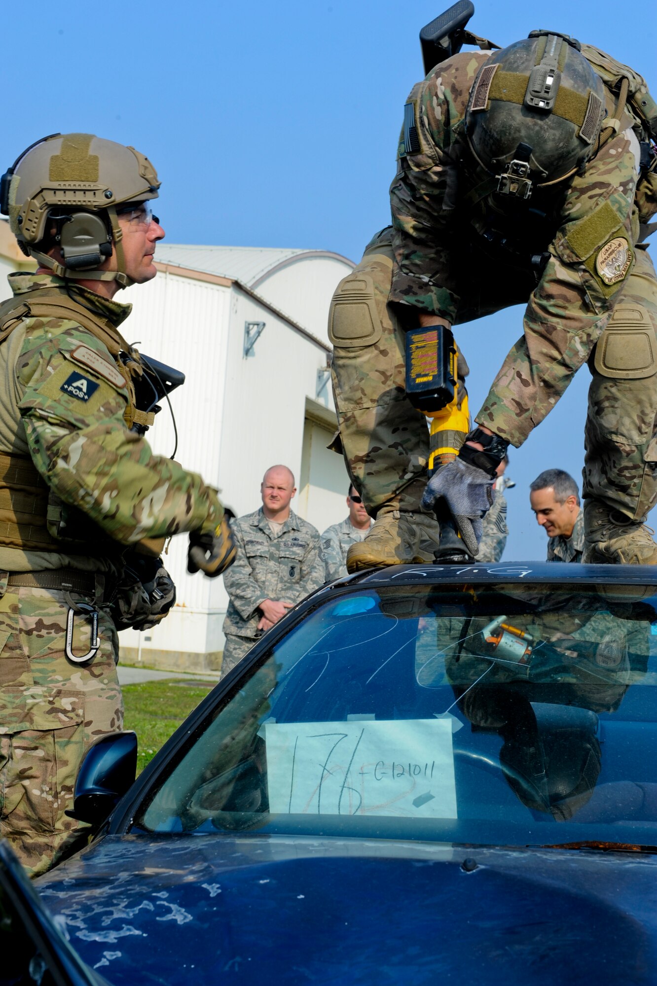 U.S. Air Force Senior Airman Michael Lindsey, 31st Rescue Squadron pararescueman, cuts into a car during a vehicle extrication demonstration on Kadena Air Base, Japan, March 6, 2013. Vehicle extrication removes a person who has been involved in a motor vehicle accident from the vehicle when conventional means of exit are impossible or inadvisable.  (U.S. Air Force photo/Airman 1st Class Justin Veazie)