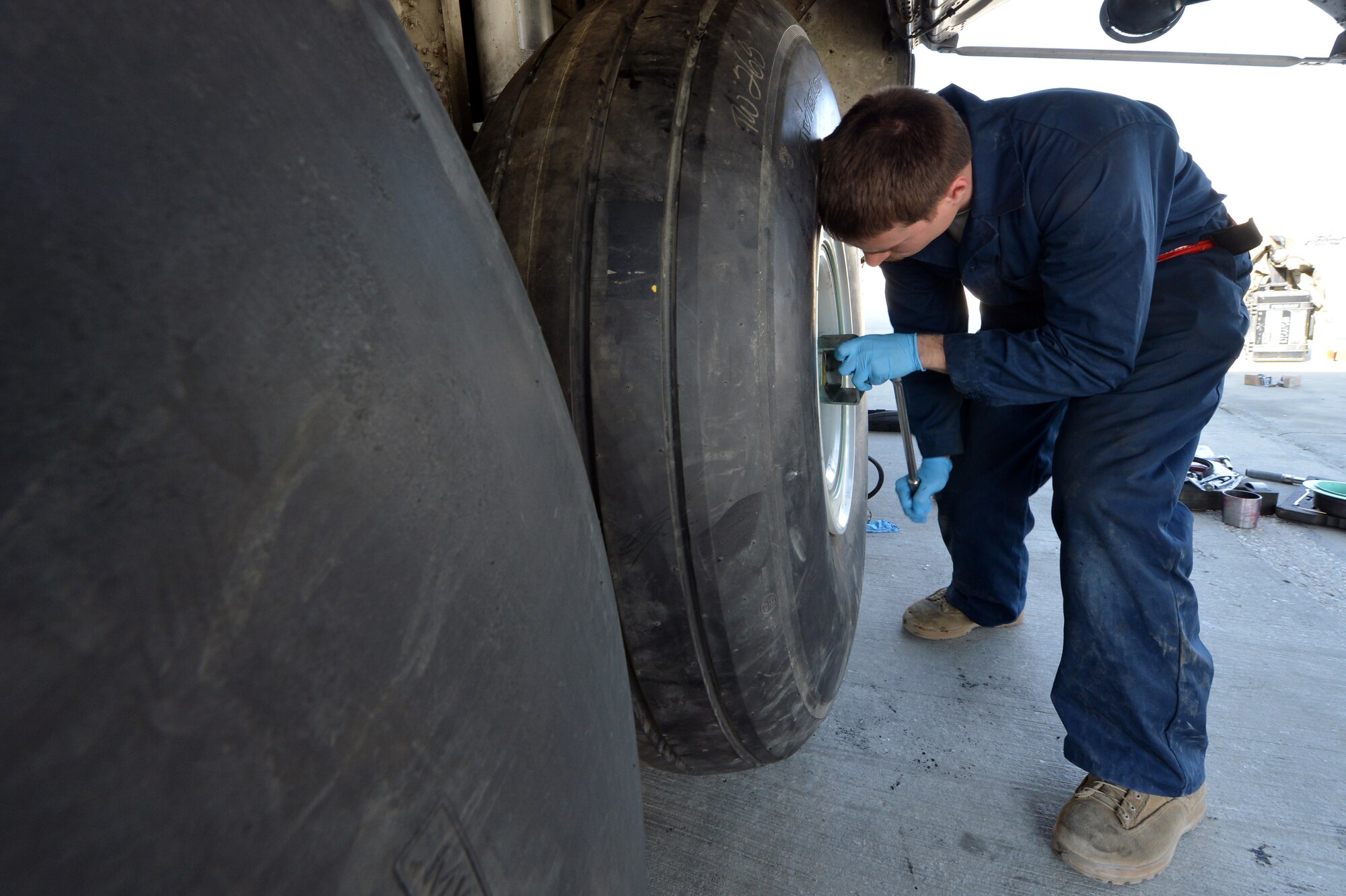 Senior Airman Zach Pectol, 455th Expeditionary Aircraft Maintenance Squadron crew chief, replaces a tire on a C-130 Hercules on Bagram Airfield, Afghanistan, March 6, 2013.The 455th EAMXS is responsible for preparing military aircraft on Bagram for flight and returning them to a mission-ready state once they land. (U.S. Air Force photo/Senior Airman Chris Willis)