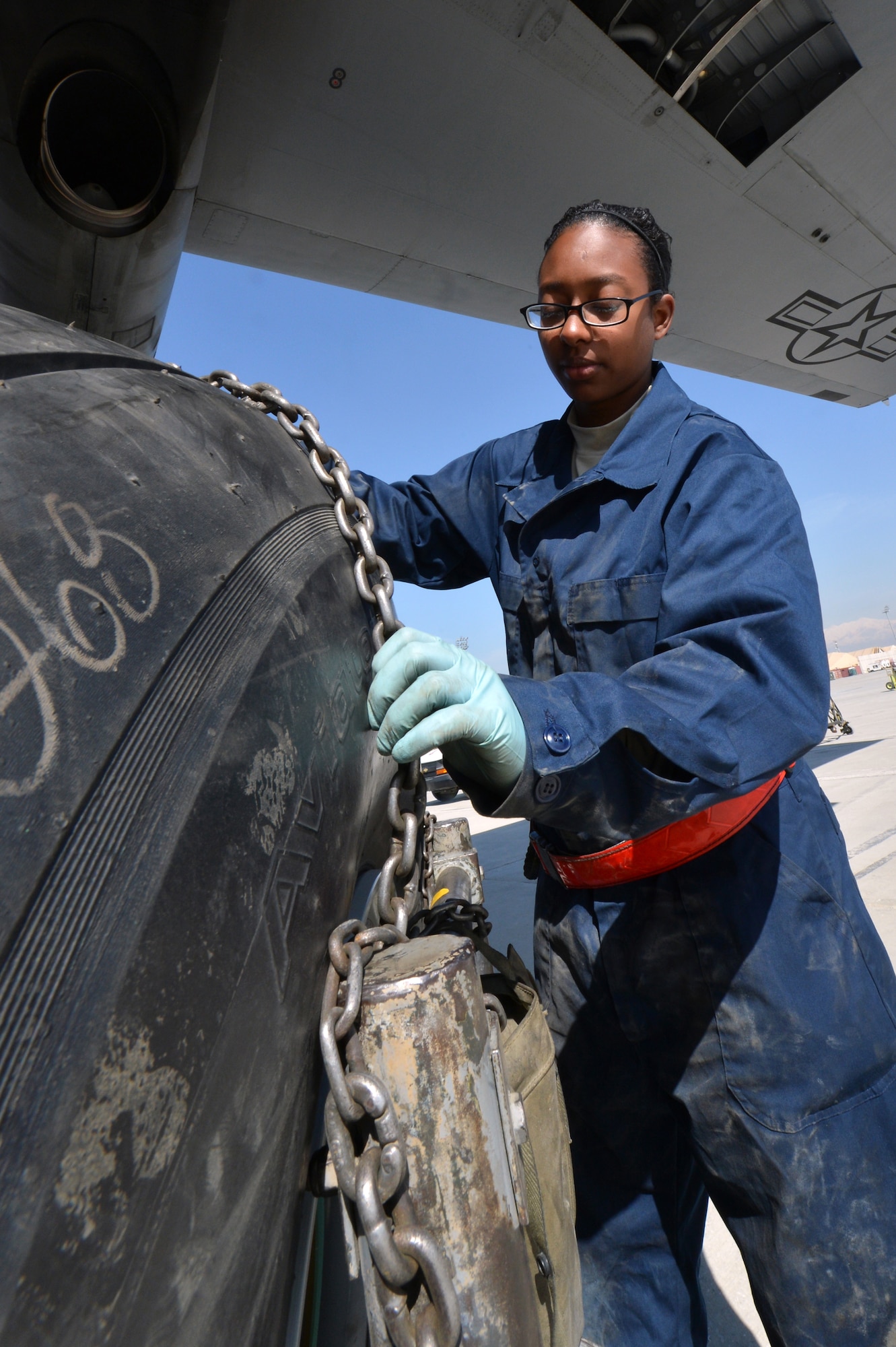 Senior Airman Mai Anderson, 455th Expeditionary Aircraft Maintenance Squadron crew chief, replaces a tire on a C-130 Hercules on Bagram Airfield, Afghanistan, March 6, 2013.  The 455th EAMXS is responsible for repairing and maintaining military aircraft on Bagram as well as performing preventative maintenance inspections. (U.S. Air Force photo/Senior Airman Chris Willis)