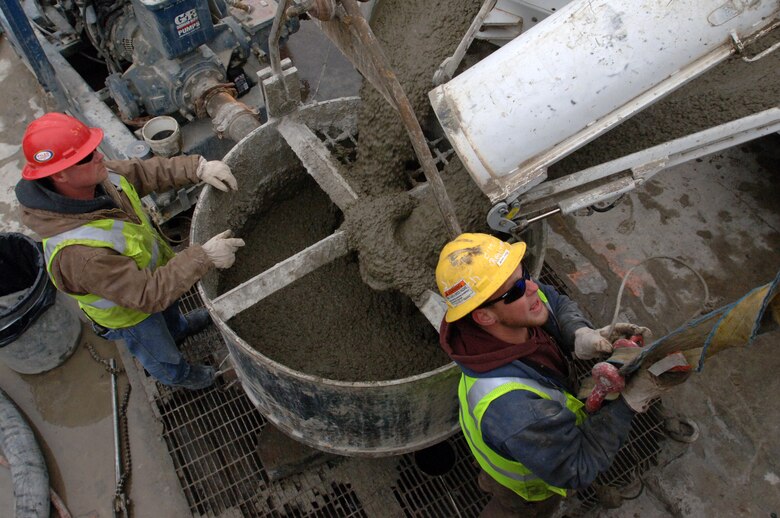 Construction workers place concrete in the last pile to complete the barrier wall at Wolf Creek Dam in Jamestown, Ky., March 6, 2013.  It is the last of 1,197 piles that are approximately four feet in diameter and extend 275 feet into bedrock below the foundation of the 4,000-foot long embankment. The completion makes it possible to begin the process of raising the Lake Cumberland pool level. (USACE photo by Lee Roberts)
