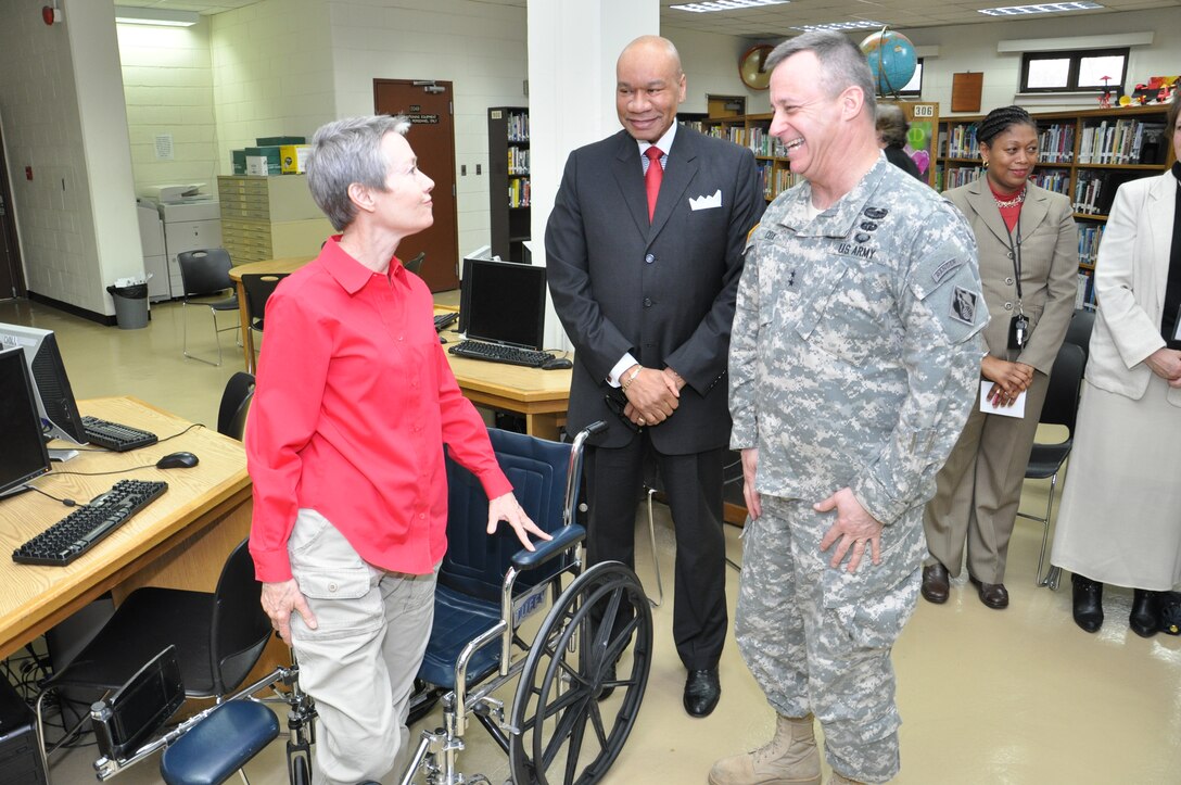 Maj. Gen. Kendall Cox, U.S. Army Corps of Engineers deputy commanding general for military and international operations, laughs with Kathleen Reiss, the principal of Seoul American High School.  The Corps of Engineers and the Department of Defense Schools Korea District signed an education partnership March 7 at the high school.  The partnership will center on support for the science, technology, engineering, and mathematics initiative, better known as STEM.  (Photo by Patrick Bray)