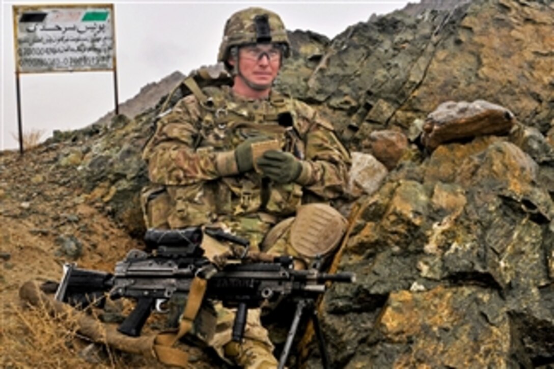 U.S. Army Spc. Bryan Gonzalez records traffic patterns at an Afghan Uniform Police traffic control point near Takhteh Pol, Afghanistan, on Feb. 26, 2013.  Gonzalez and fellow infantrymen from B Company, 2nd Battalion, 23rd Infantry Regiment, are assisting the Afghan police by advising and providing over watch security.  