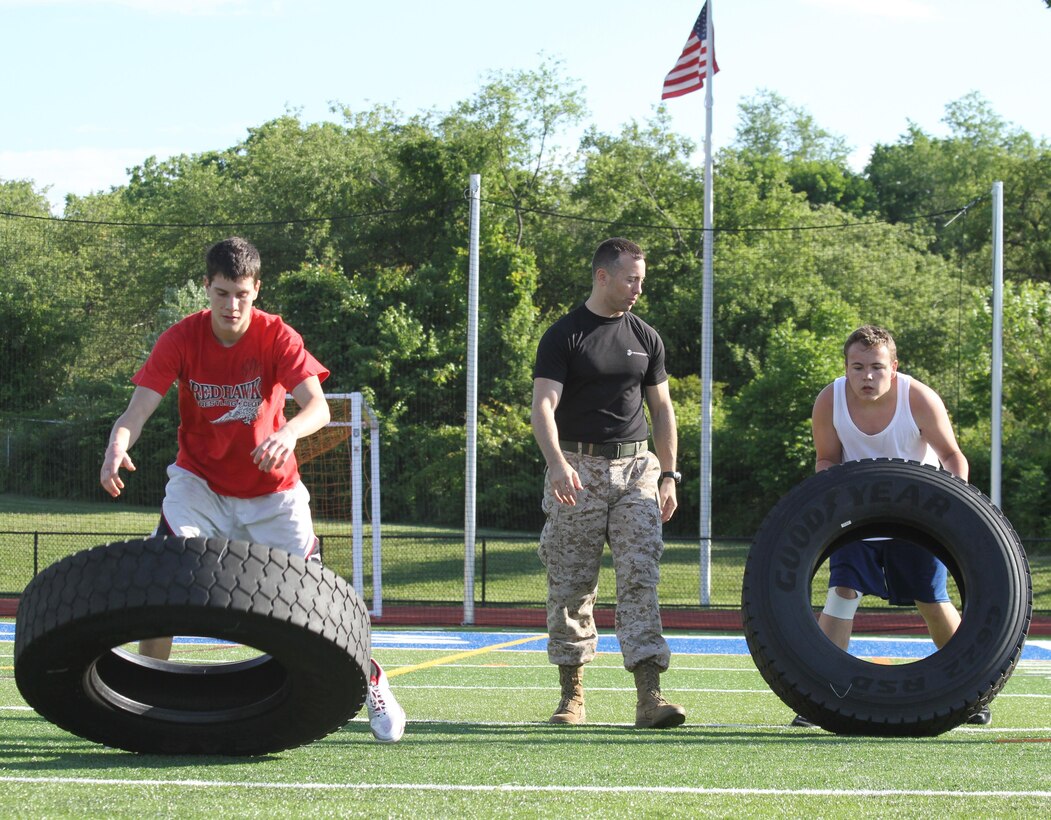 Capt. Christopher Simpson, executive officer of Recruiting Station New Jersey, motivates two Warren Hills Regional High School students during an RS New Jersey Leadership Seminar for High School Athletes June 7, 2012.  Simpson began the seminar more than two years ago.