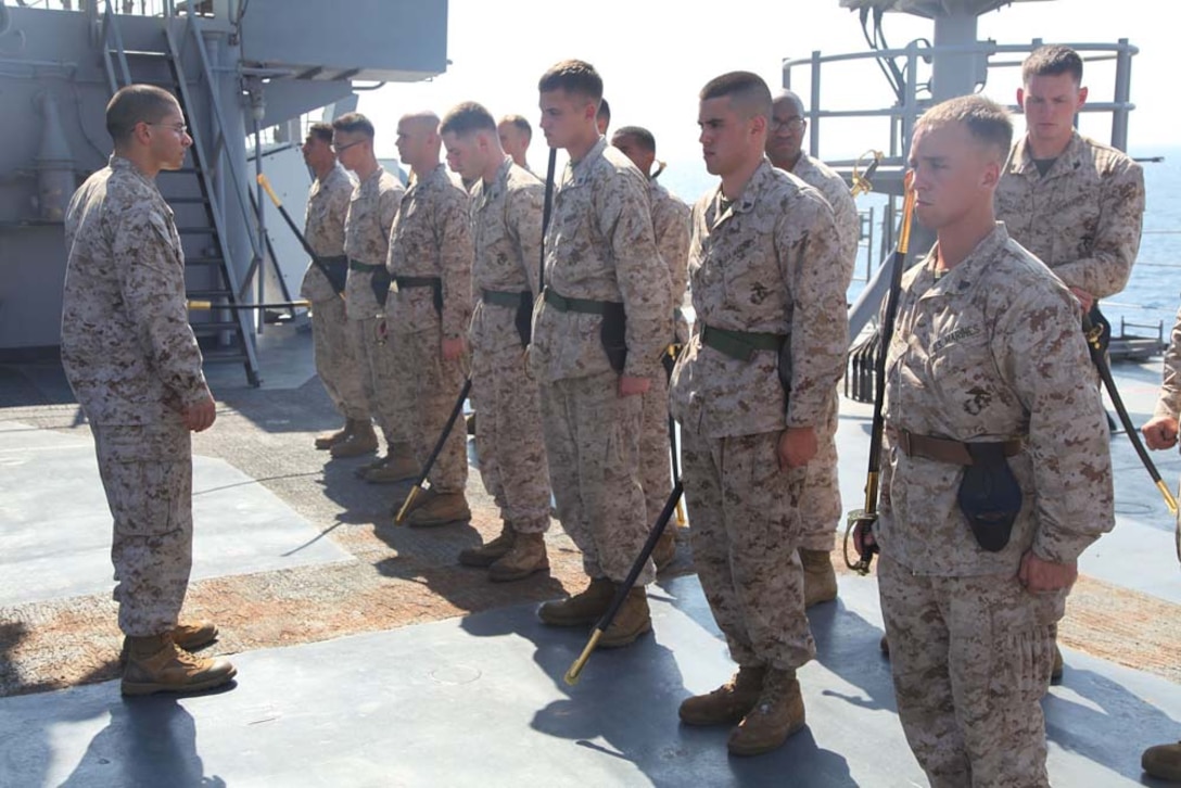 Marines assigned to the 15th Marine Expeditionary Unit practice sword manual during Corporals Course aboard the USS Rushmore, March 5. The 15th MEU is deployed as part of the Peleliu Amphibious Ready Group as a U.S. Central Command theater reserve force, providing support for maritime security operations and theater security cooperation efforts in the U.S. 5th Fleet area of responsibility. (U.S. Marine Corps photo by Cpl. Timothy R. Childers/Released)