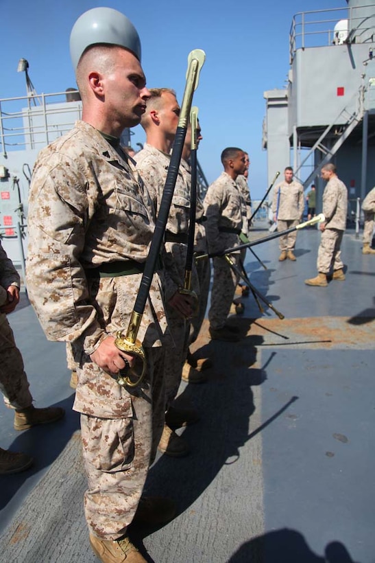 Marines assigned to the 15th Marine Expeditionary Unit practice sword manual during Corporals Course aboard the USS Rushmore, March 5. The 15th MEU is deployed as part of the Peleliu Amphibious Ready Group as a U.S. Central Command theater reserve force, providing support for maritime security operations and theater security cooperation efforts in the U.S. 5th Fleet area of responsibility. (U.S. Marine Corps photo by Cpl. Timothy R. Childers/Released)