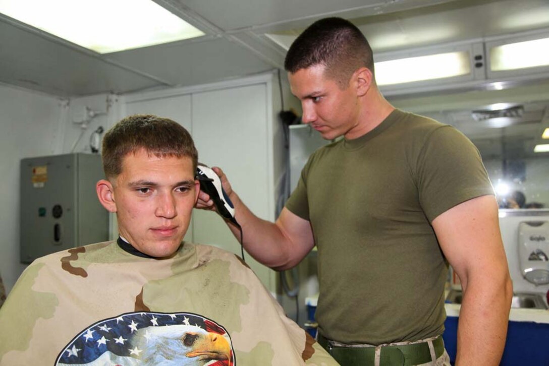 Corporal Kyle C. Sieradzki, fire direction controller, 2nd Platoon, Battery B, Battalion Landing Team 3/5, 15th Marine Expeditionary Unit, gives a haircut to Lance Cpl. Dylan M. Blea, a motor transportation operator in the same platoon, aboard USS Rushmore, March, 7. While deployed, Marines practiced and honed the valuable skill of cutting hair taking the place of civilian barbers. The 15th MEU is deployed as part of the Peleliu Amphibious Ready Group as a U.S. Central Command theater reserve force, providing support for maritime security operations and theater security cooperation efforts in the U.S. 5th Fleet area of responsibility. (U.S. Marine Corps photo by Cpl. Timothy R. Childers/Released)