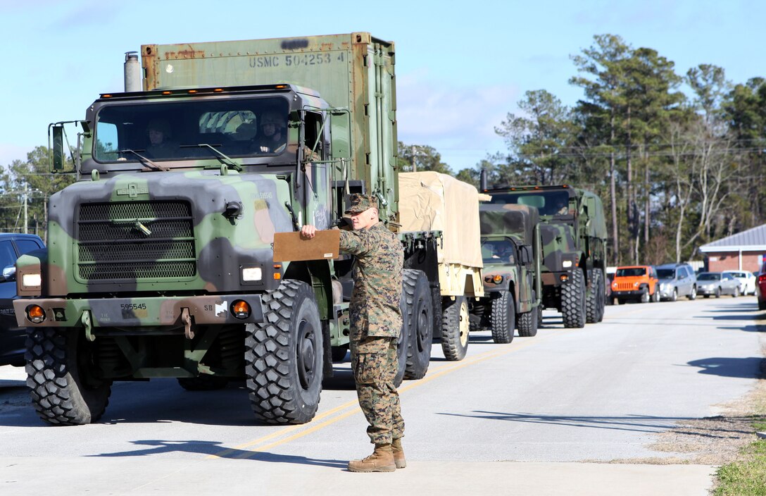 A Marine with 2nd Longshoreman Platoon directs traffic while training to conduct port operations for African Lion 2013, an annual training exercise between US African Command and Morocco, while training at Stone Bay, a satellite installation of Marine Corps Base Camp Lejeune Feb. 8. The Marines will handle the offloading and uploading of equipment to support African Lion 13.