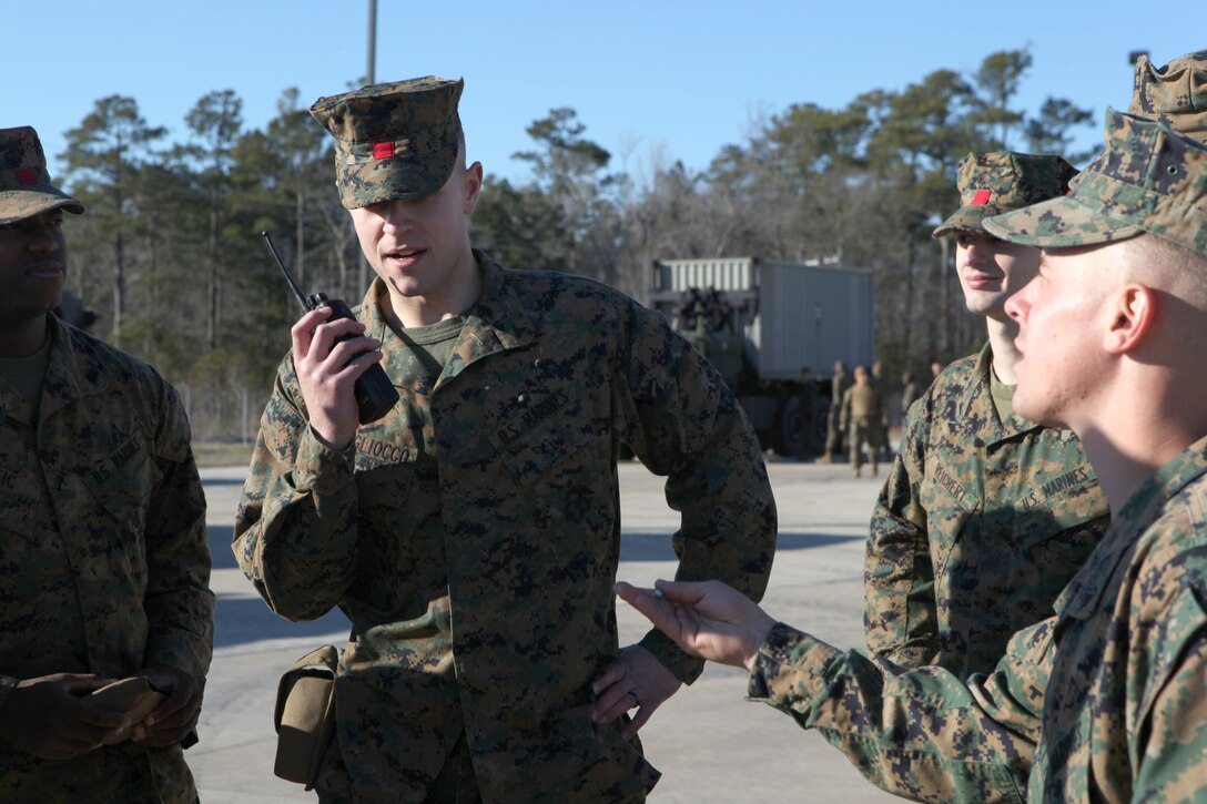 A Marine speaks into a radio while training to conduct port operations for African Lion 2013, an annual training exercise between US African Command and Morocco, while training at Stone Bay, a satellite installation of Marine Corps Base Camp Lejeune Feb. 8. The Marines will handle the offloading and uploading of equipment to support African Lion 13.