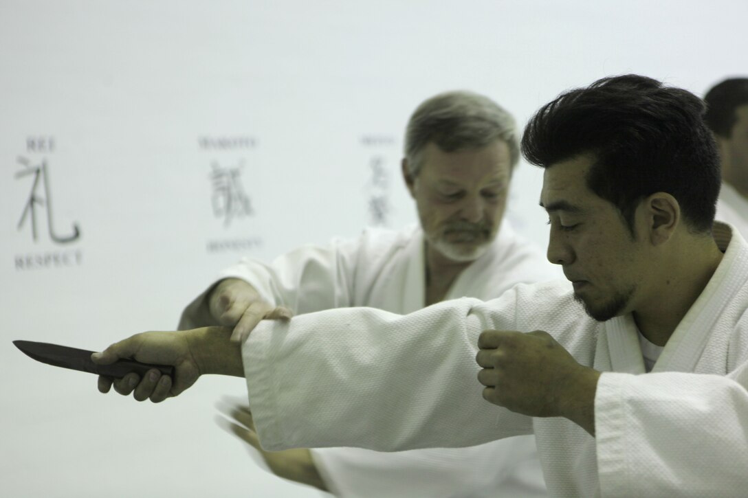 Wayne Nelson, the senior instructor of the Traditional Jujitsu Class aboard Marine Corps Base Camp Lejeune demonstrates technique on Xavier Turcotte, a seven year martial artist, Feb. 5. Nelson teaches methods of self defense to Marines, dependants, retirees and civilian employees twice a week at Building 39, next to the Goettge Memorial Field House aboard the base.
