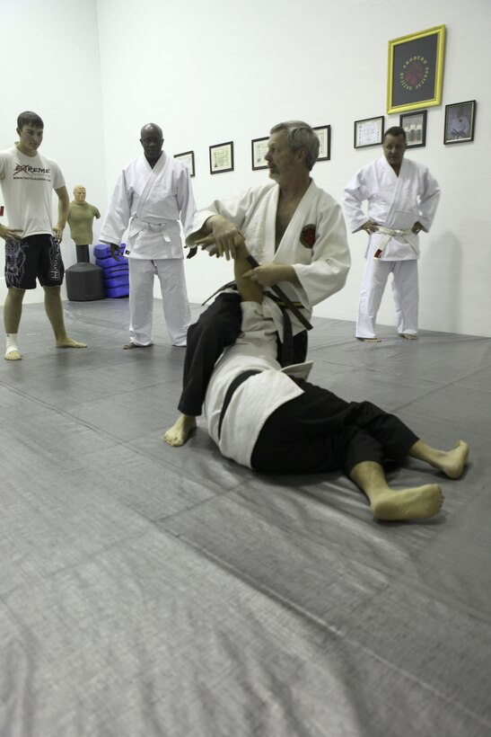 Wayne Nelson, the senior instructor of the Traditional Jujitsu Class aboard Marine Corps Base Camp Lejeune demonstrates technique on Xavier Turcotte, a seven year martial artist, Feb. 5. Nelson teaches methods of self defense to Marines, dependants, retirees and civilian employees twice a week at Building 39, next to the Goettge Memorial Field House aboard the base.