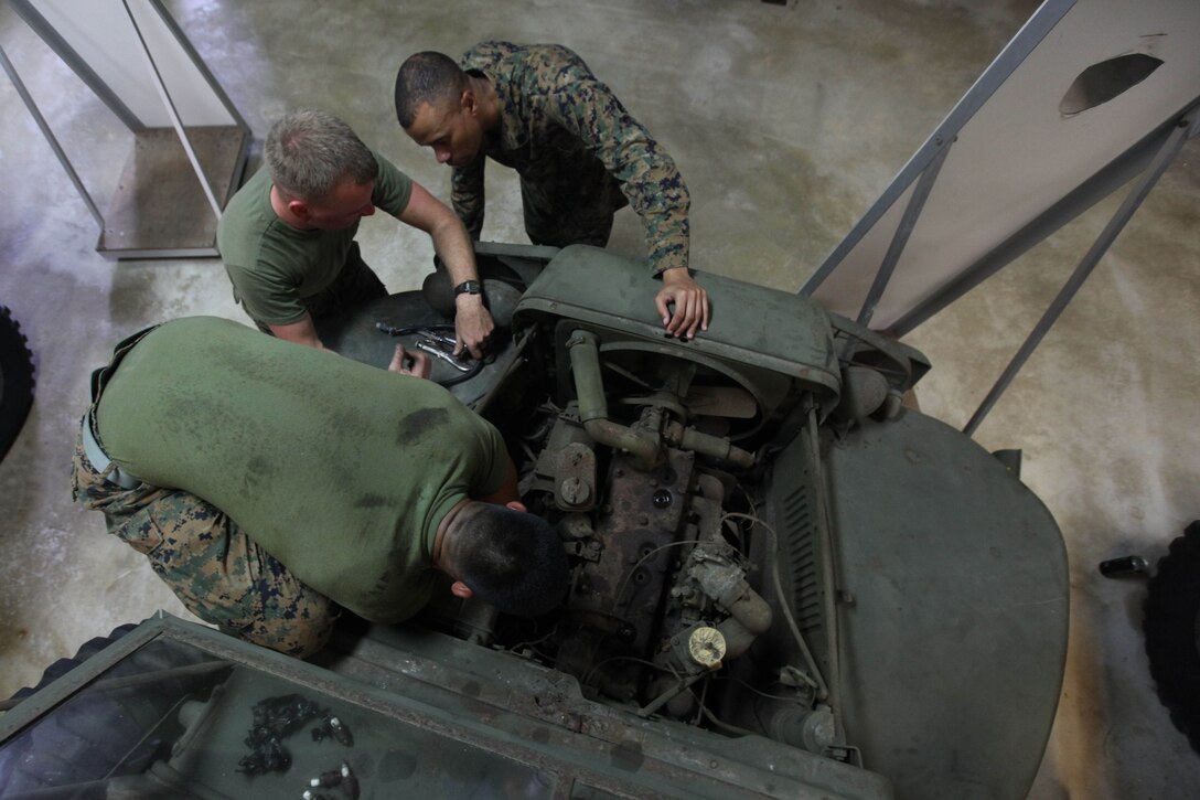 Motor Transport Marines with Combat Logistics Detachment 39 work on a truck on exhibit at the Pacific War Museum Feb. 27.  CLD 39 is deployed in support of Exercise Guahan Shield, an exercise that will facilitate multiservice engagement, set conditions for bilateral and multilateral training opportunities, and support rapid response to potential theater crises and contingency operations in the Asia-Pacific region.  CLD-39 is part of 9th Engineer Support Battalion, 3rd Marine Logistics Group, III Marine Expeditionary Force.  