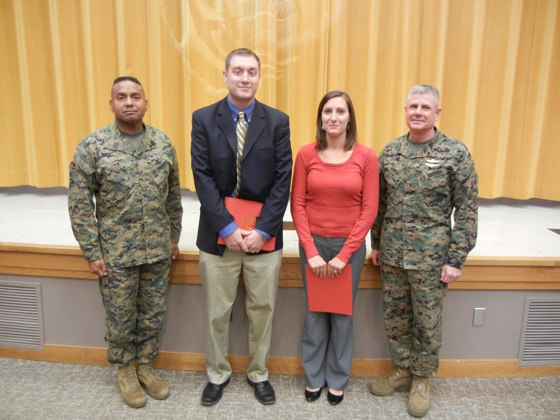Sgt. Maj. Howard Long, sergeant major of Training and Education Command, left, and Maj. Gen. Thomas Murray, commander of TECOM, pose with National Museum of the Marine Corps curator/specialist team members Stefan Rohal and Alexis Thompson, who received outstanding service awards for their handling of an incident involving potential radiation exposure at the museum. 